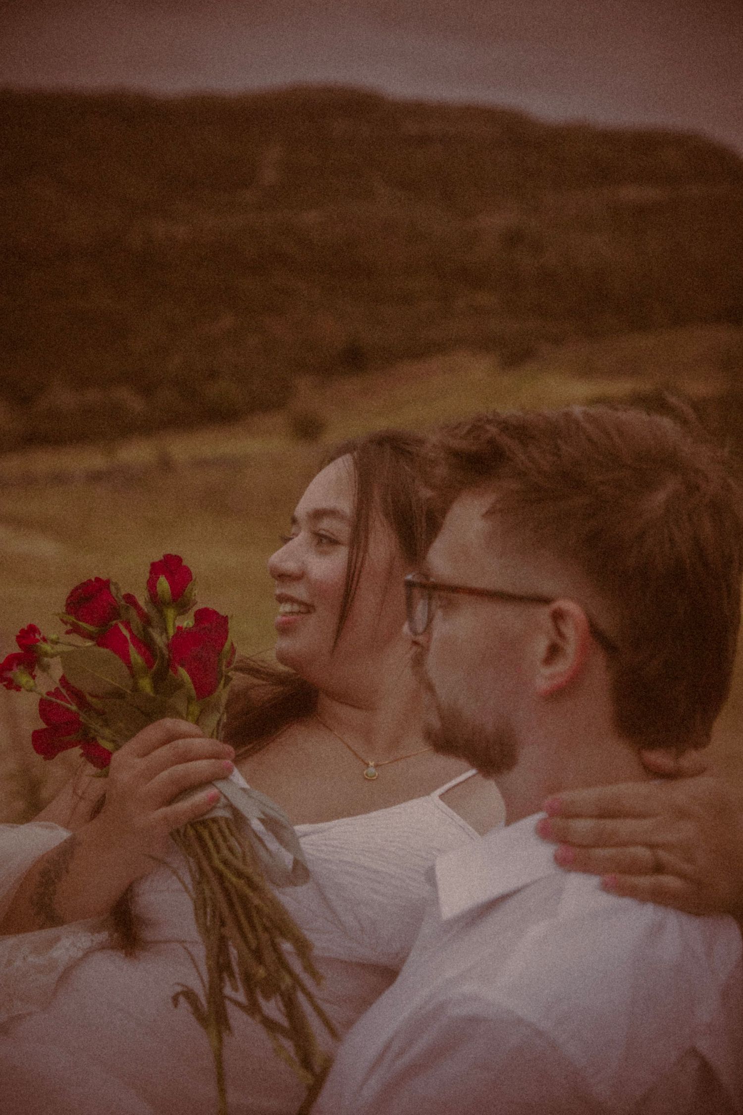 groom-carrying-bride-in-arms-after-countryside-elopement-in-edinburgh
