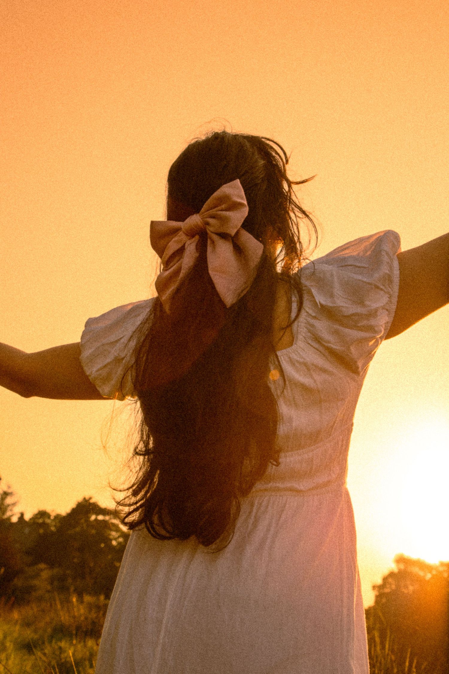 cinematic-photograph-of-a-girl-basking-in-the-setting-sun-in-the-countryside