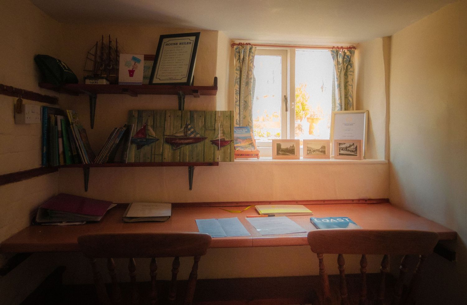 Rustic interior room with wooden shelves and natural light streaming through window.