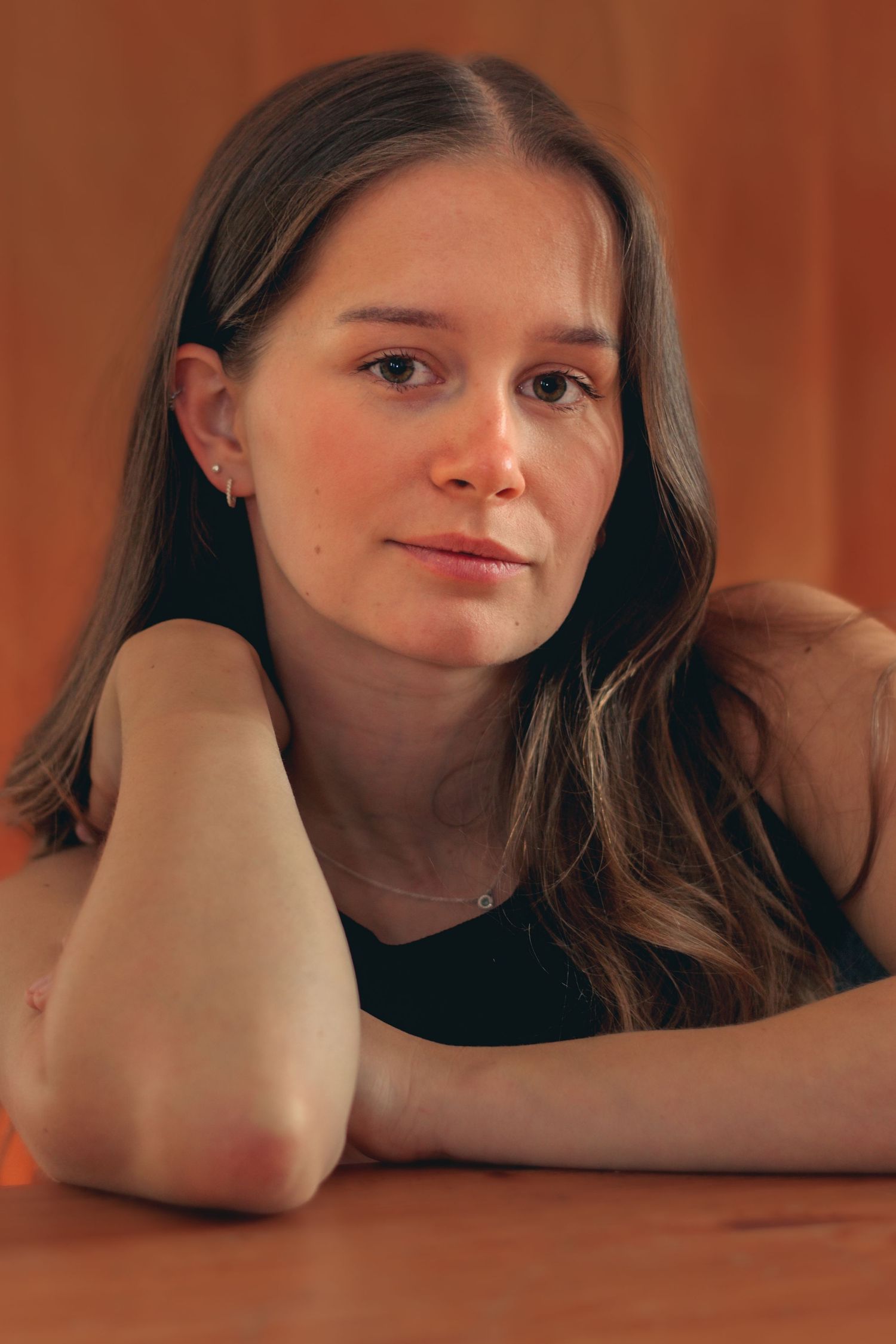 Portrait series on wooden surface with warm orange lighting.