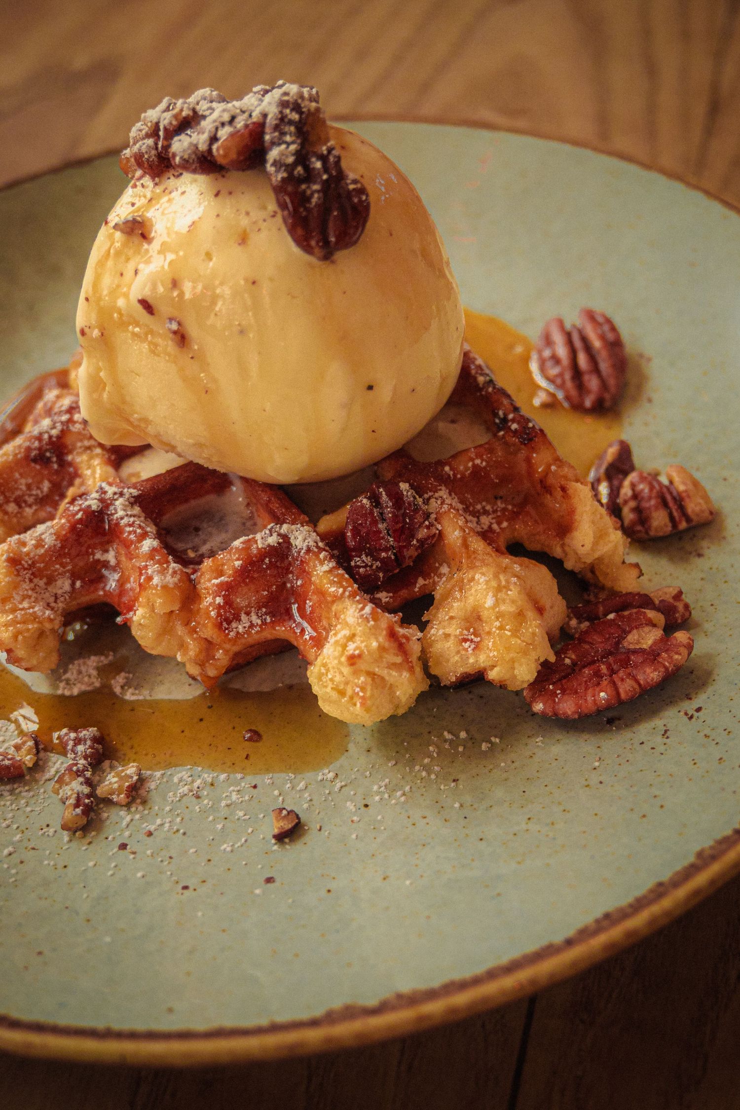 Gourmet dessert plate featuring caramelized nuts and glazed fruit on a rustic ceramic dish.