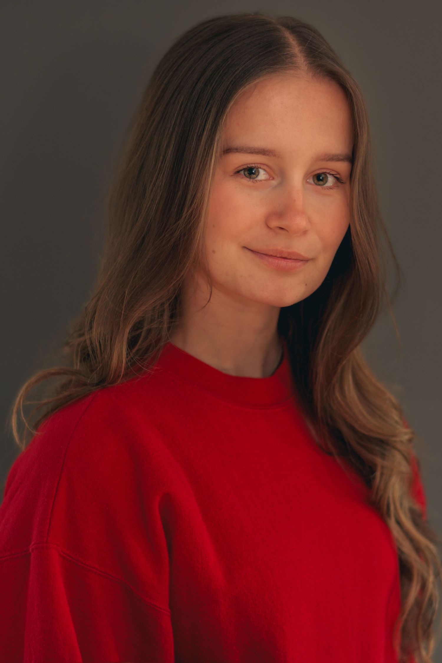 Portrait sequence in bright red sweater against dark background.