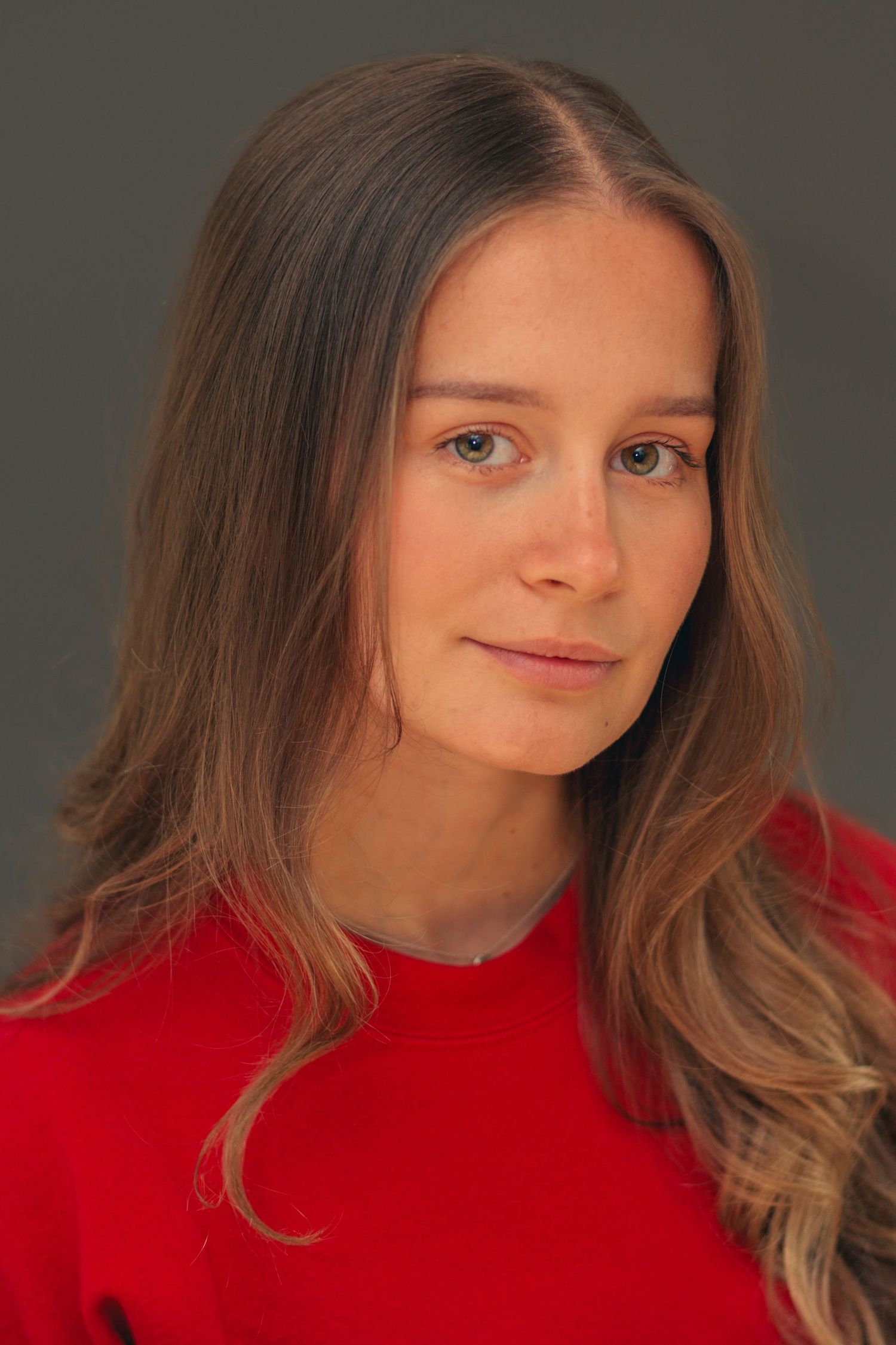 Close-up portrait series in red sweater showing various expressions.
