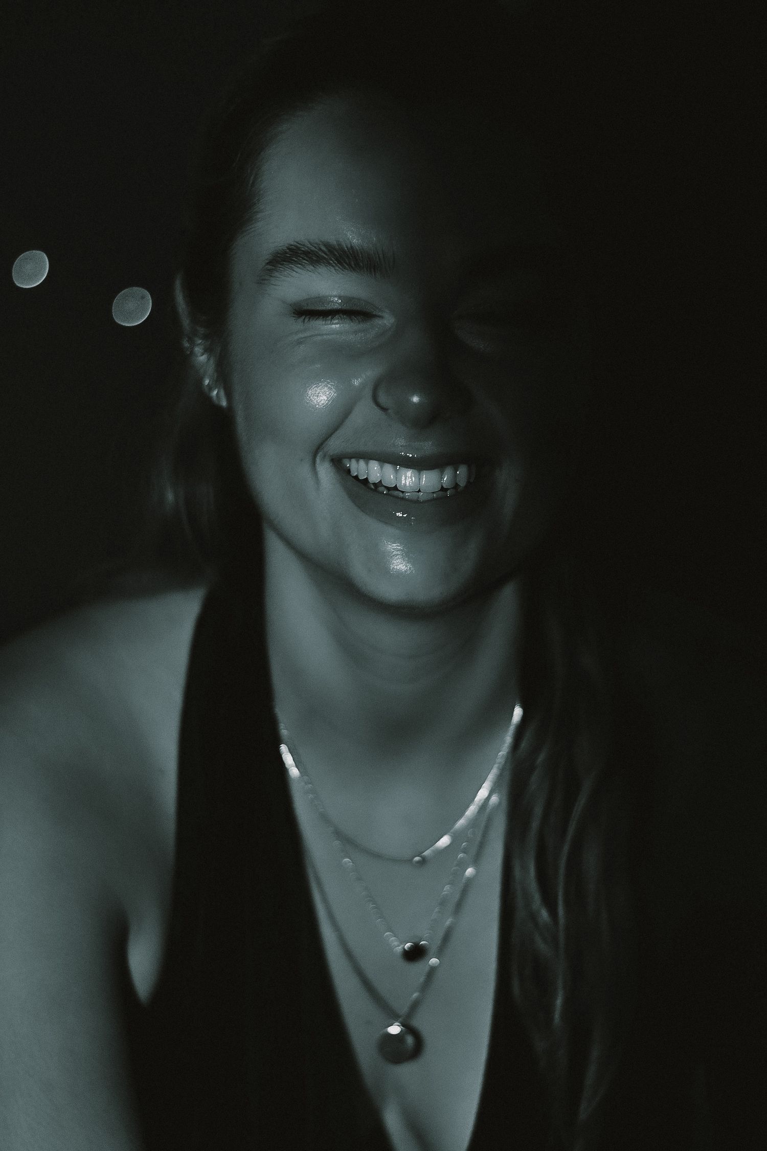 Black and white nighttime portraits showing joyful expressions and necklace details.