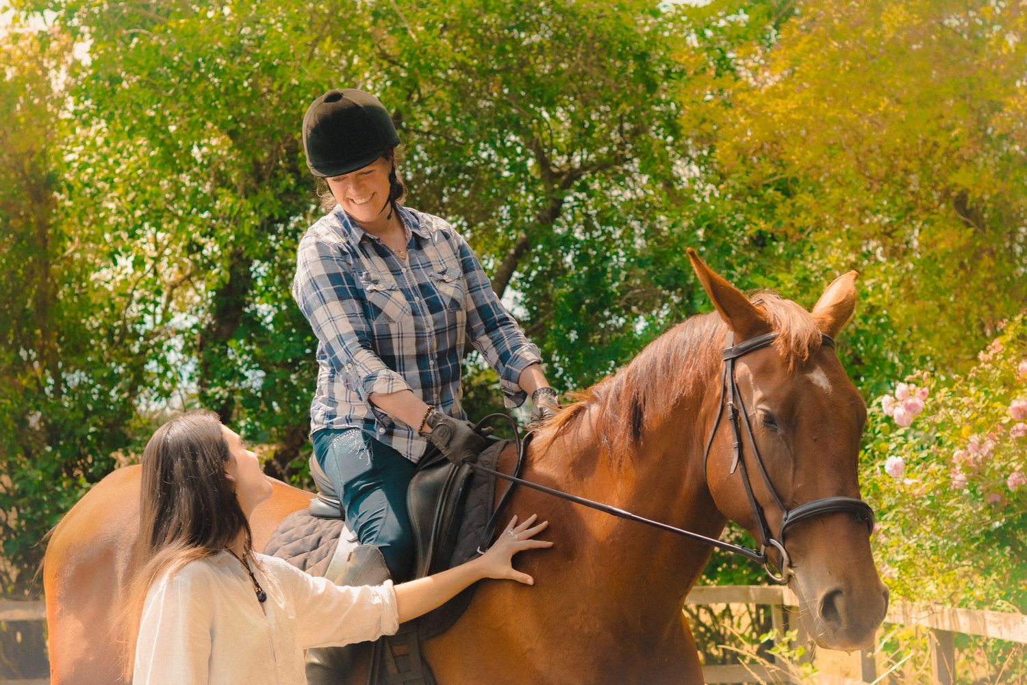 Horseback riding lesson taking place among fall trees with golden leaves.