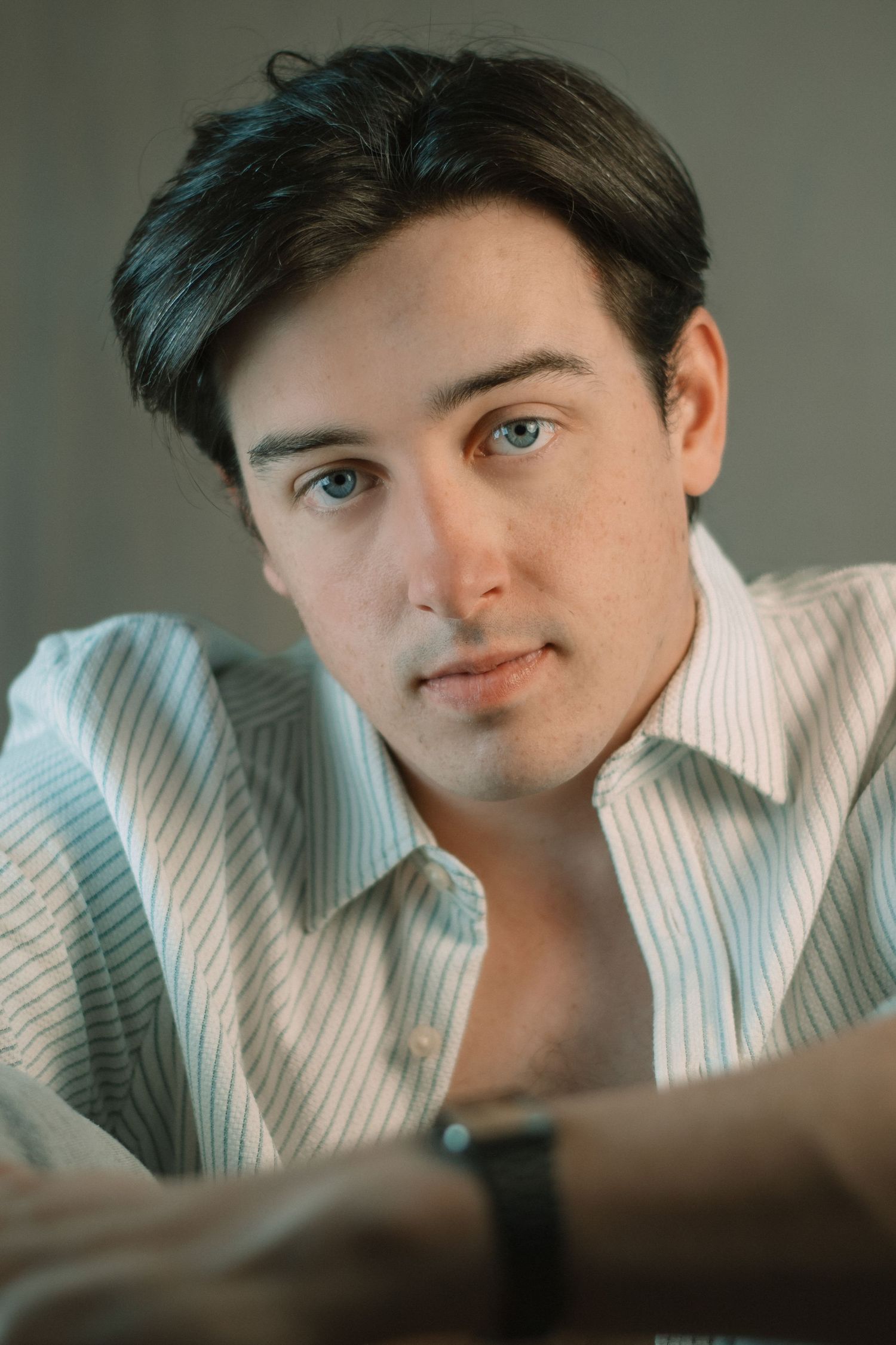 Portrait series showing close-up expressions with soft lighting and a white collared shirt.