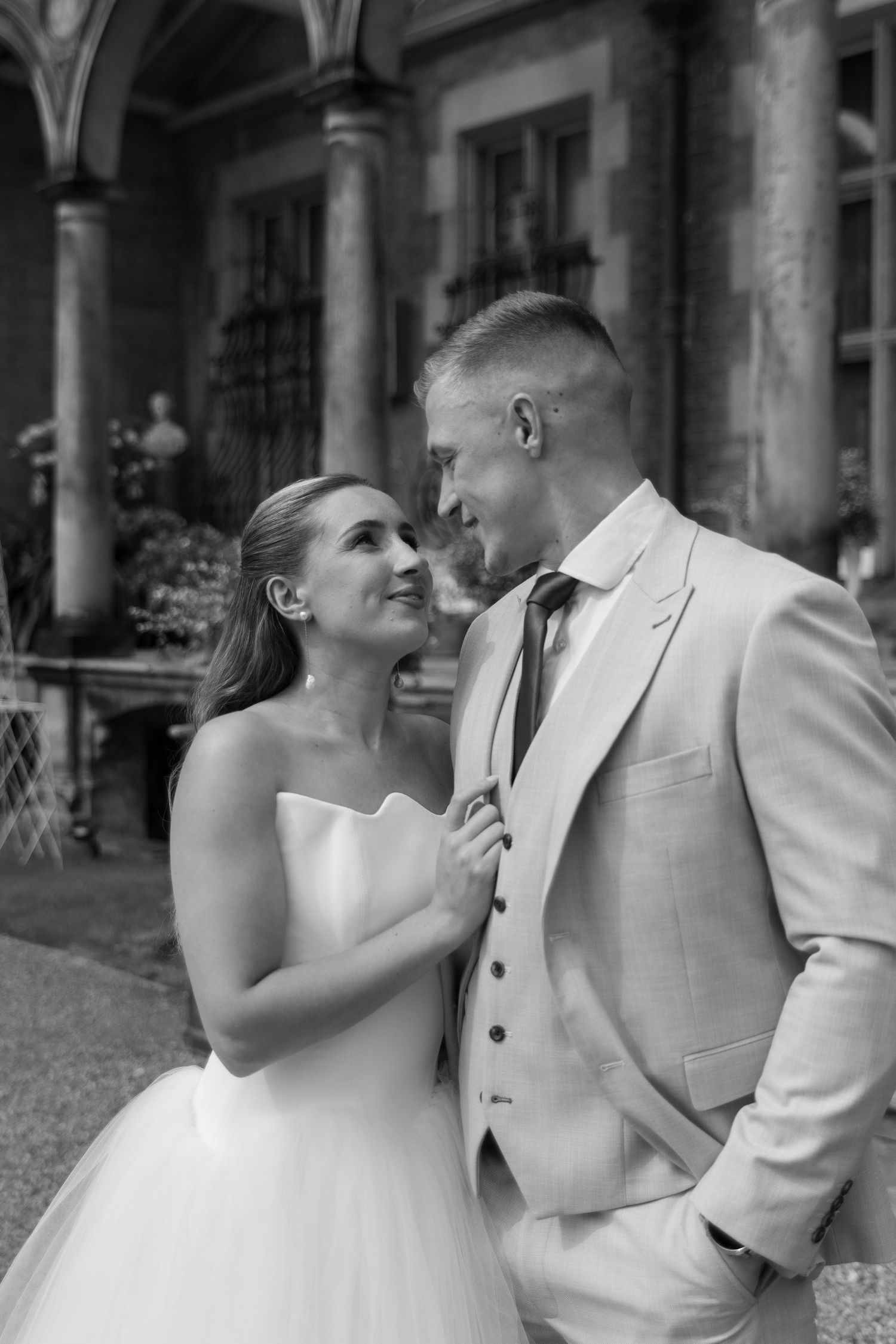 A romantic black and white photo series capturing newlyweds sharing intimate moments at their venue.