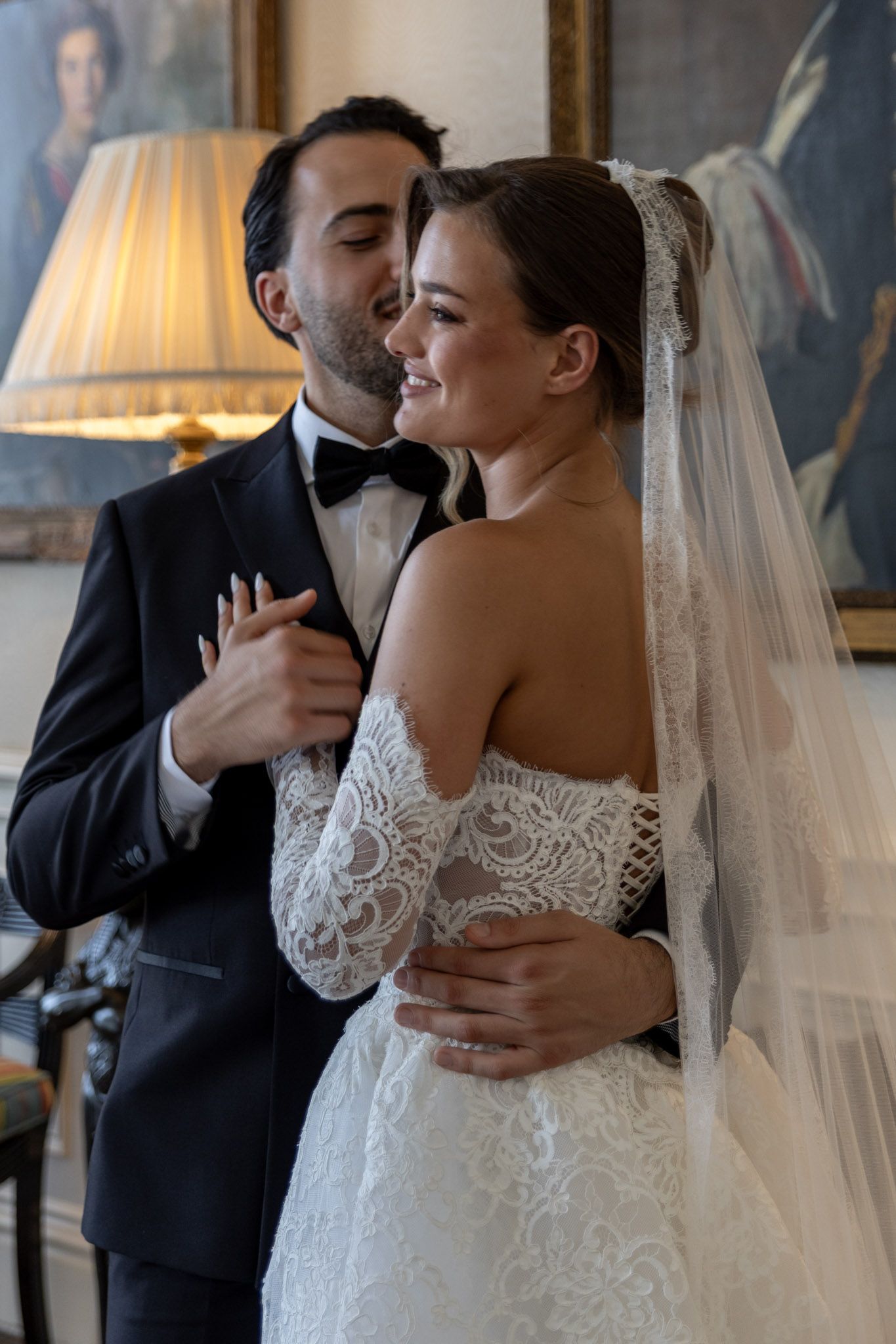 An intimate wedding moment captured indoors with warm lighting and classic decor.