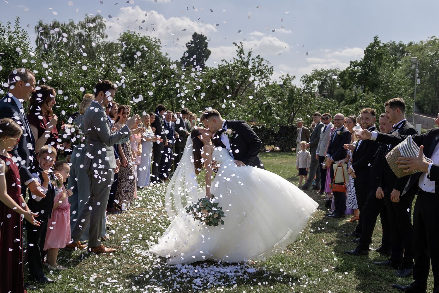 A sequence of wedding celebration photos showing confetti being thrown over a couple in an outdoor garden setting.