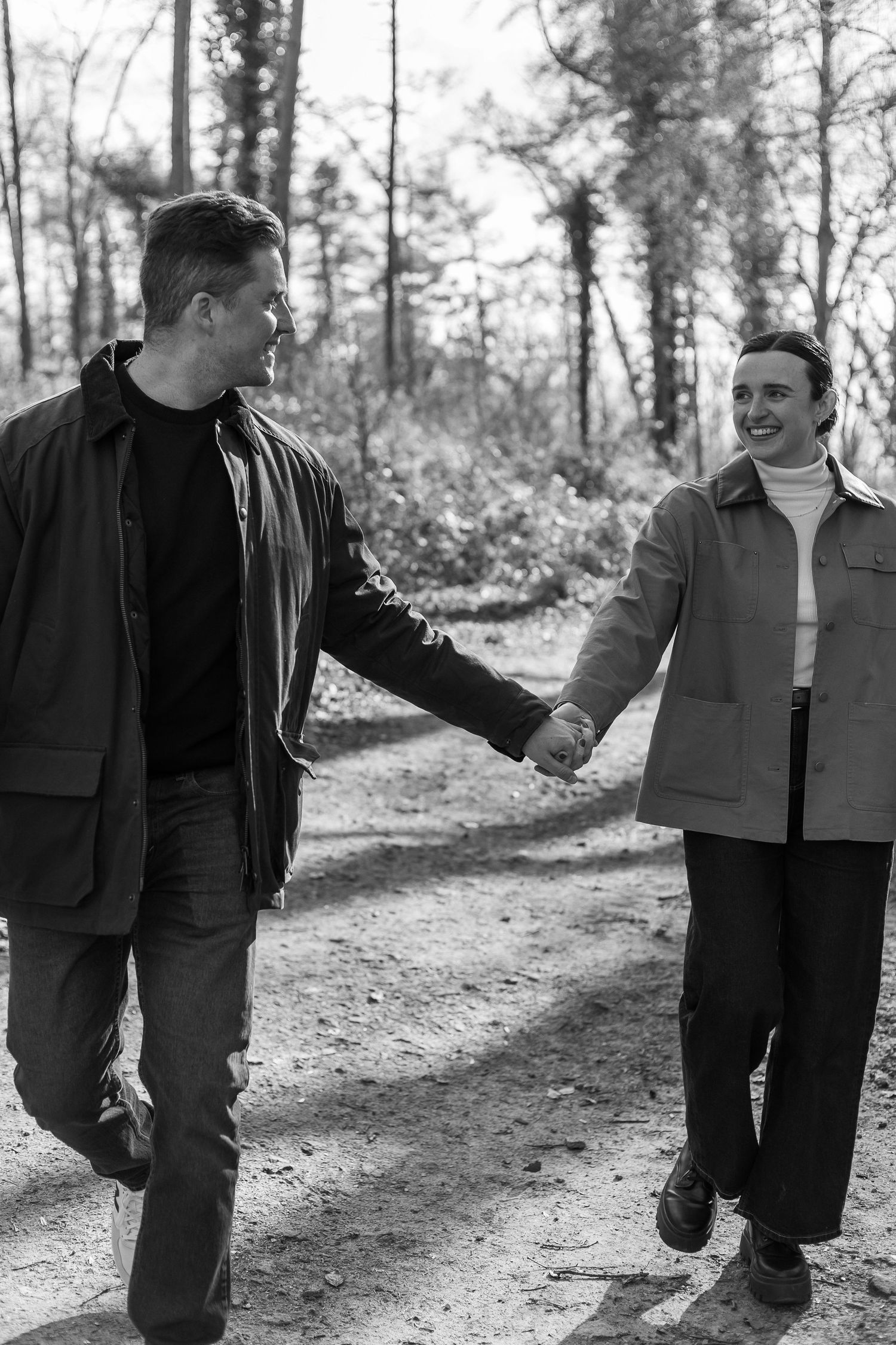 Black and white photo sequence showing two people walking together on a forest path.