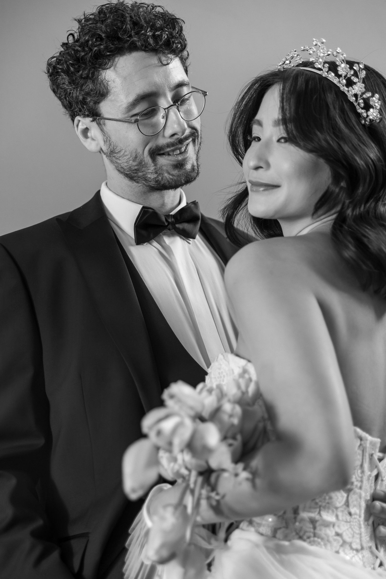 A romantic black and white wedding photo sequence showing a couple sharing intimate moments and laughter together.