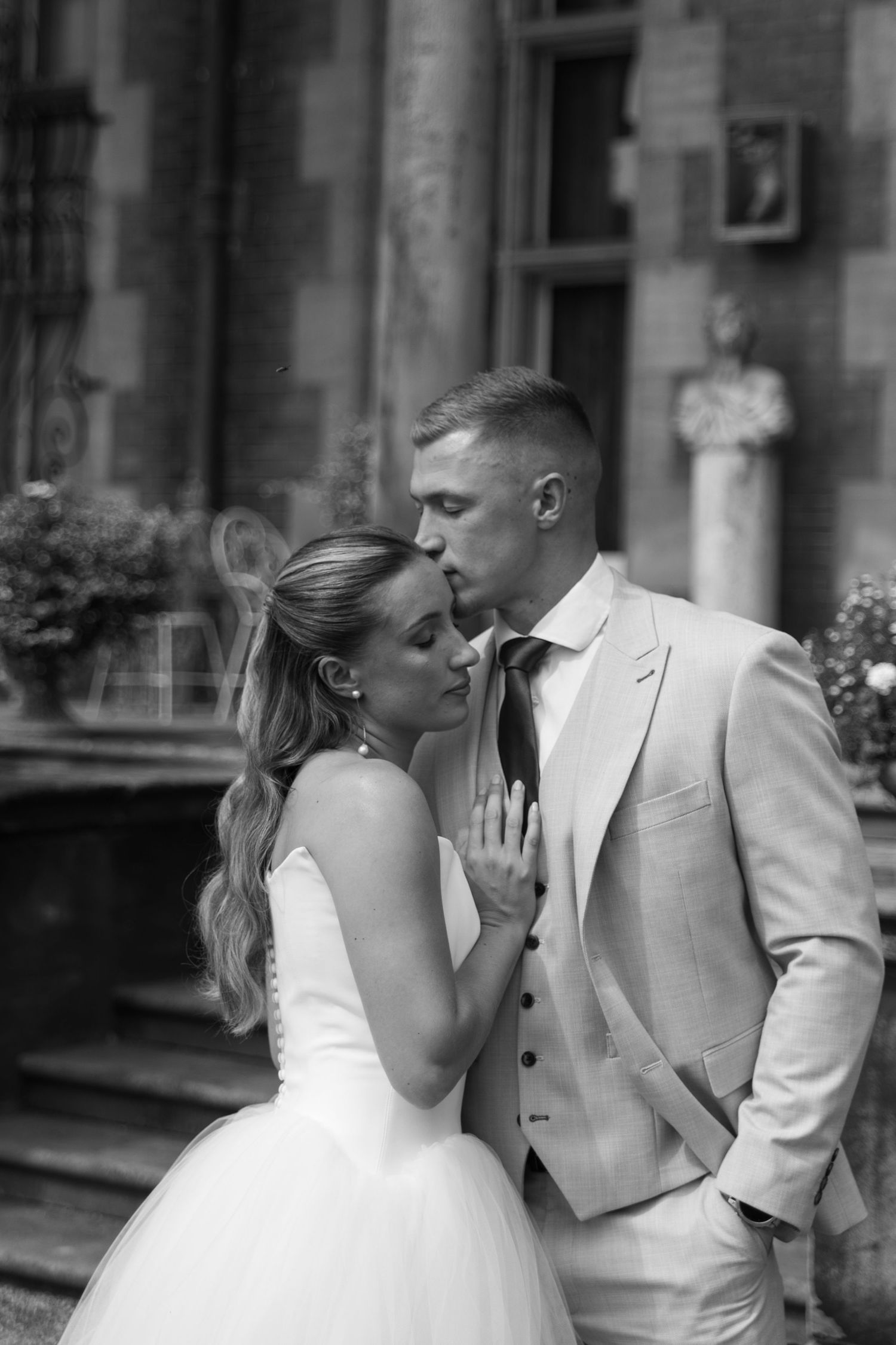 A series of candid black and white photos capturing a sweet moment between newlyweds.