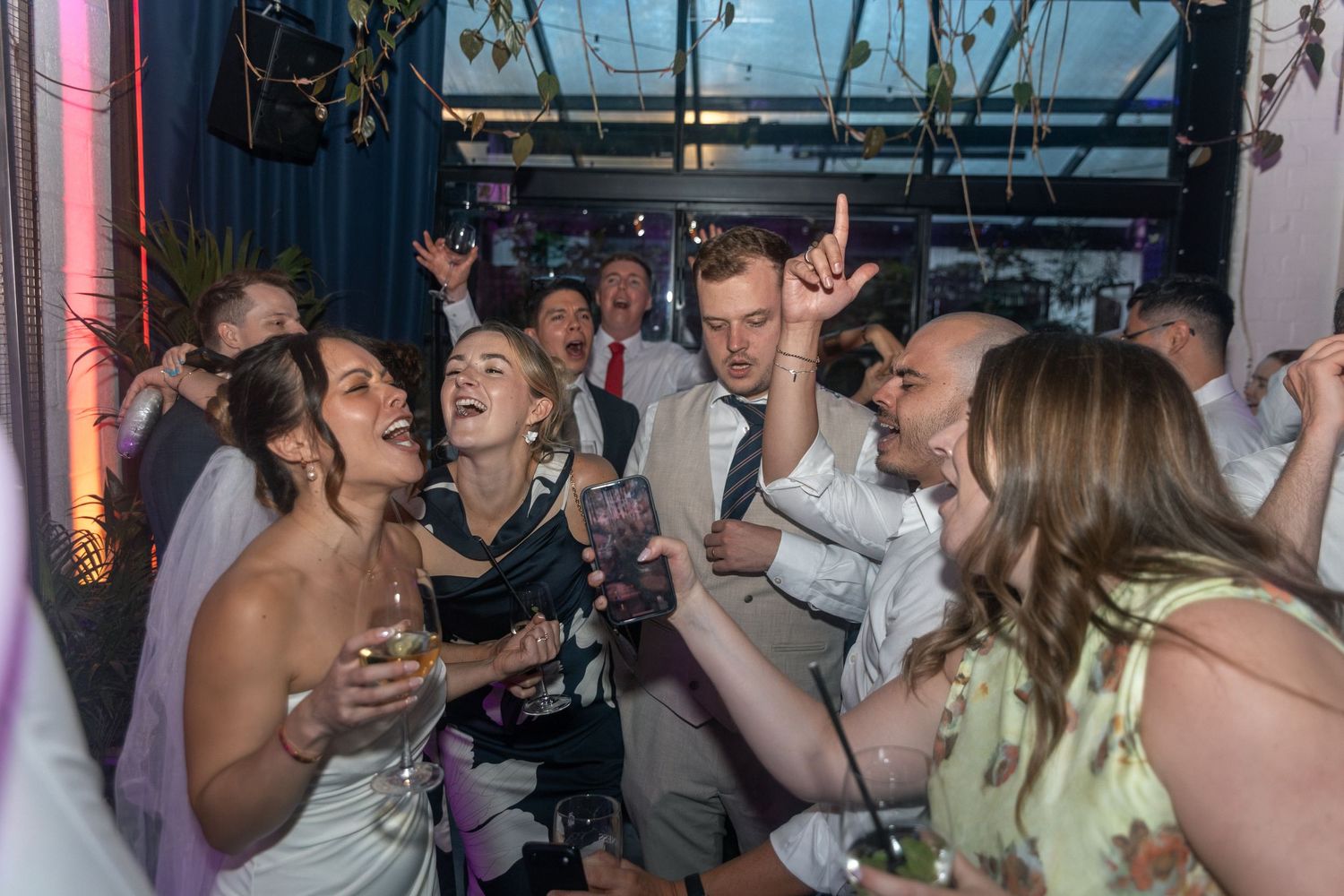 Guests dancing and celebrating joyfully at a lively wedding reception party at The Hackney