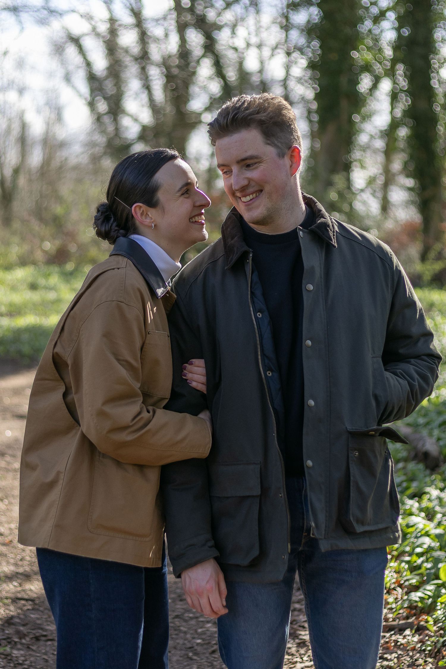 Three candid photos of a couple sharing intimate moments together outdoors on a winter day.