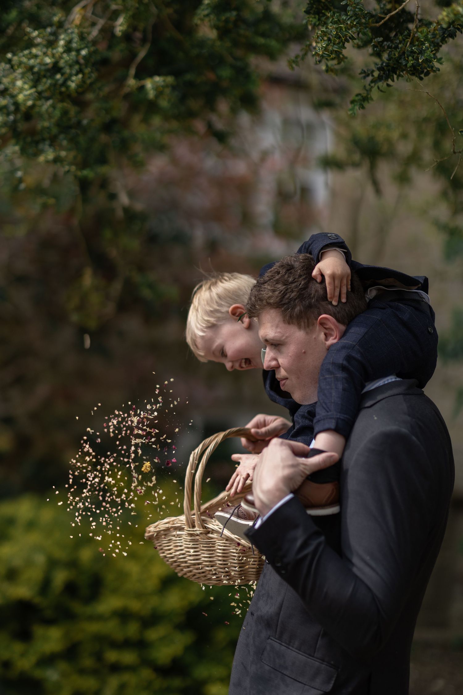 A playful moment with flower petals being tossed from a basket.