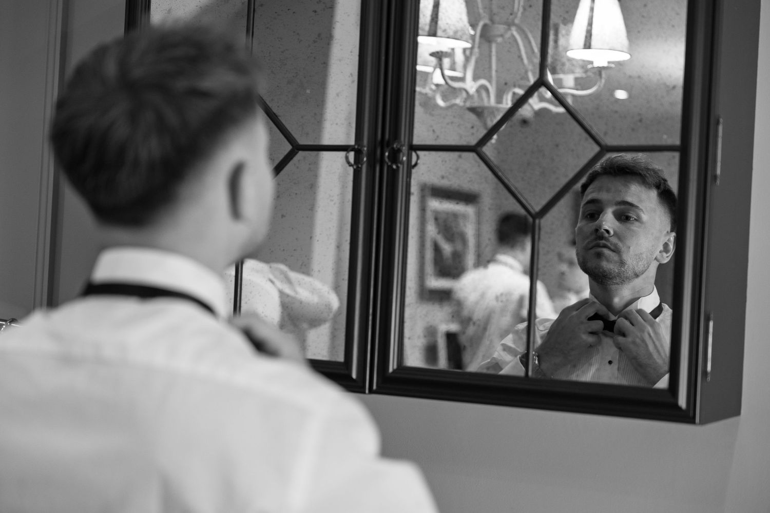 A person is seen through a window reflection while working in what appears to be an office or business setting.