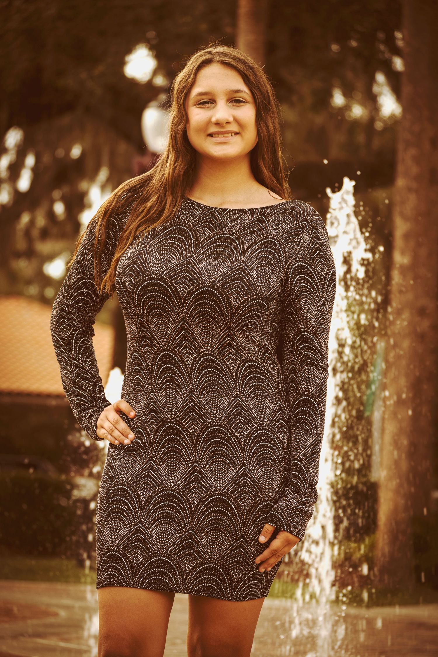 Natural light portrait of a woman wearing a patterned top during an outdoor photography session.