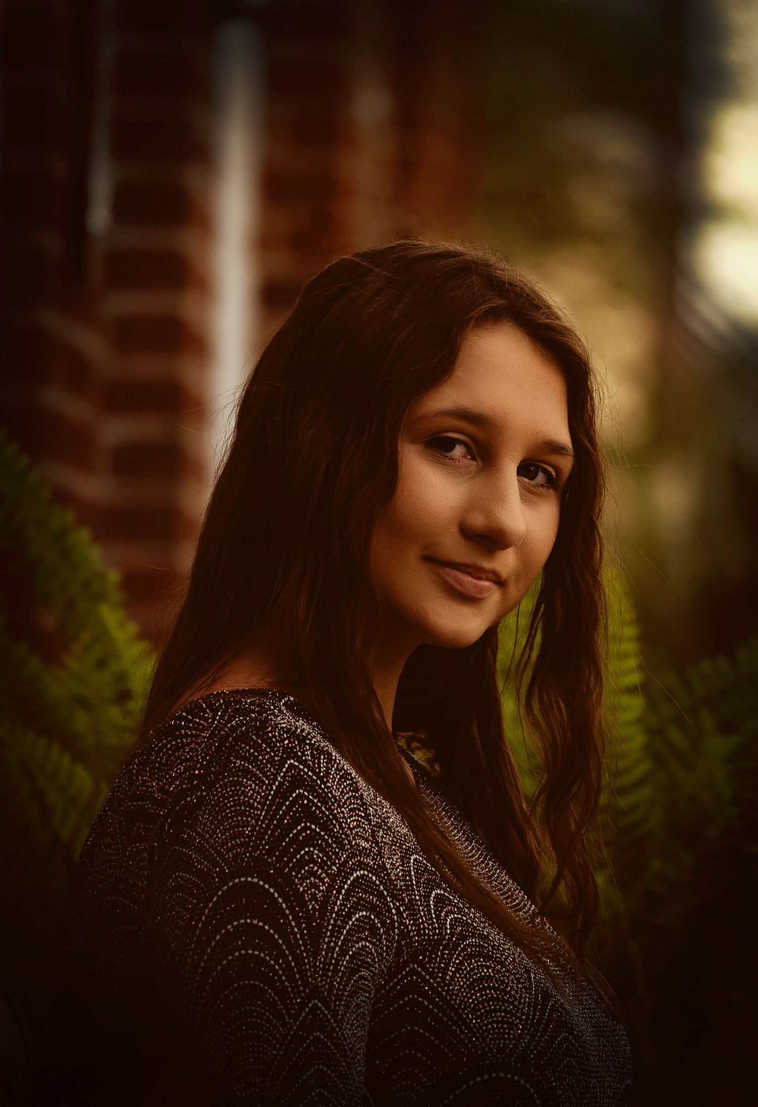 Portrait photograph taken outdoors using natural light and soft background blur.