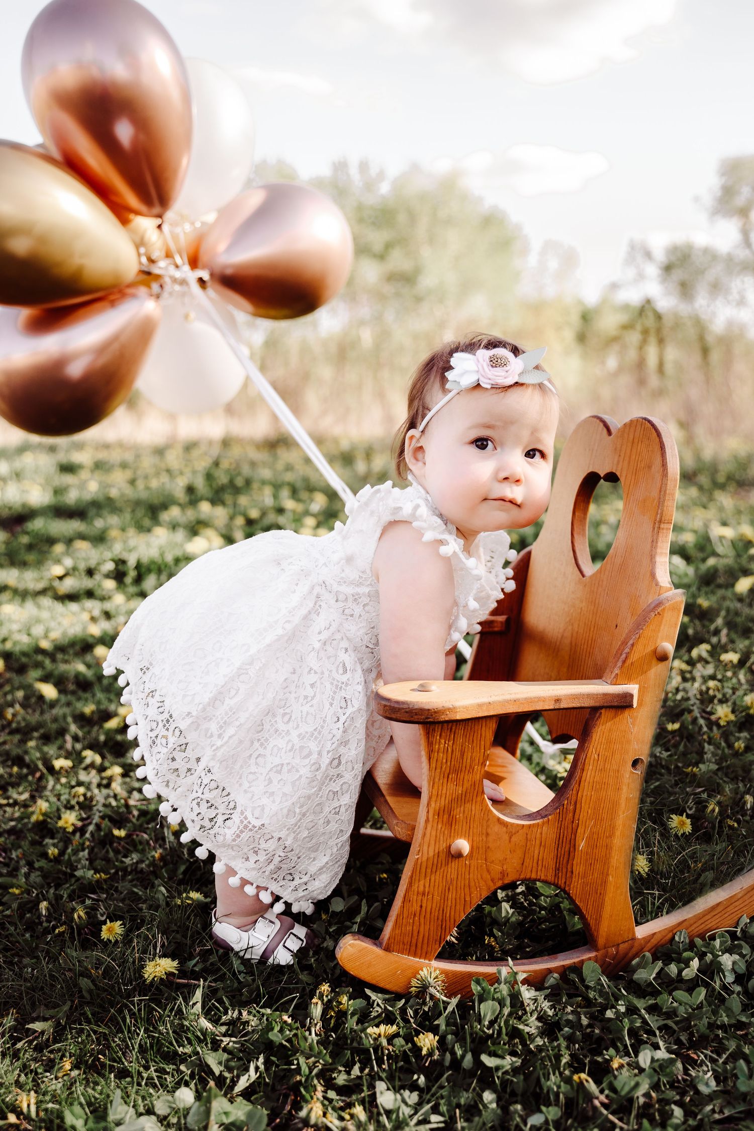 baby girl milestone picture with pink balloons