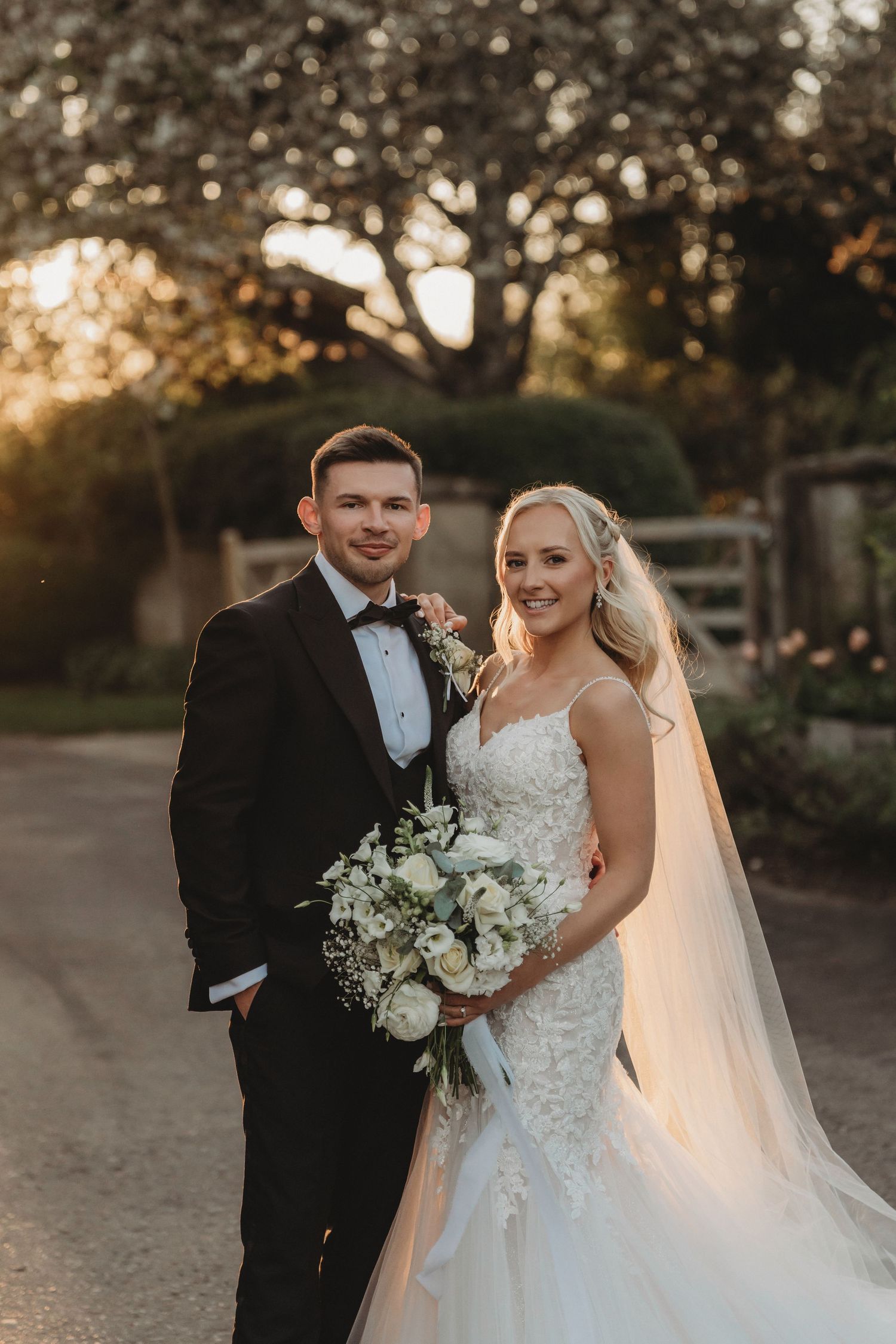 sunset couple portrait and clock barn. wedding photographers