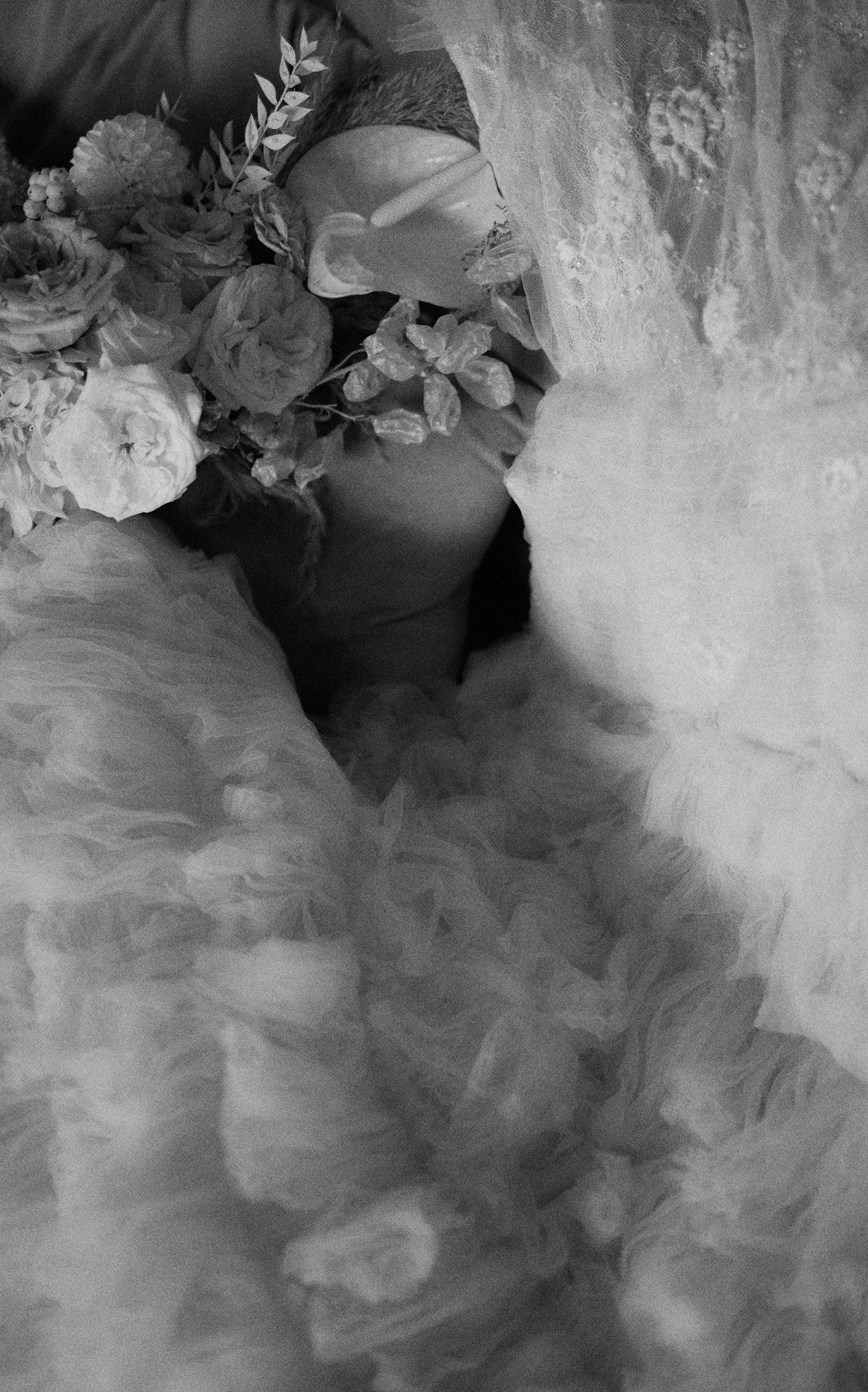 Detail shot of intricate beadwork on bride’s wedding gown train