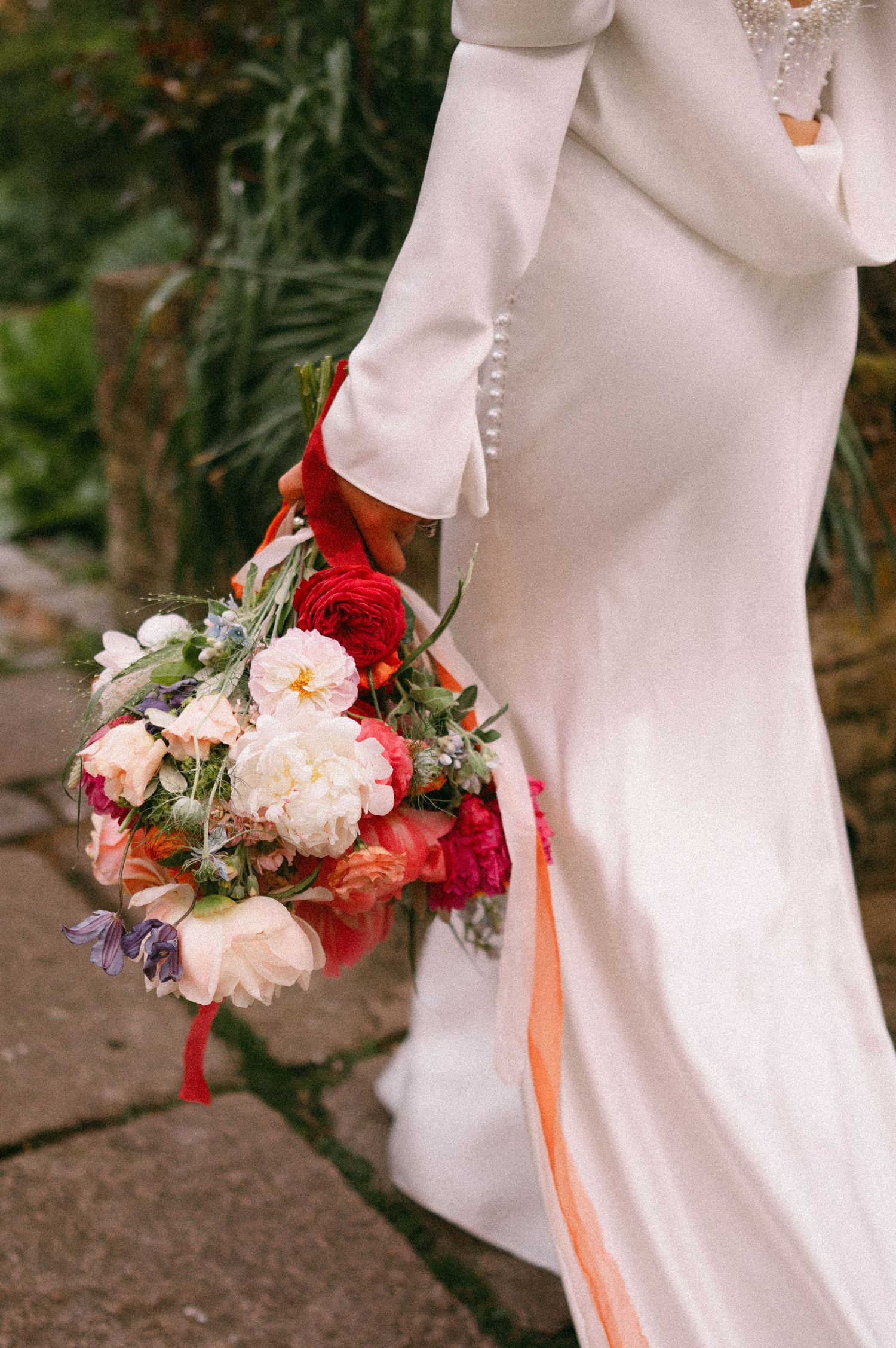 Close-up of white wedding dress and romantic red and pink bridal bouquet.  Aberdeen wedding photographer, Logie country house, Kim Dalglish