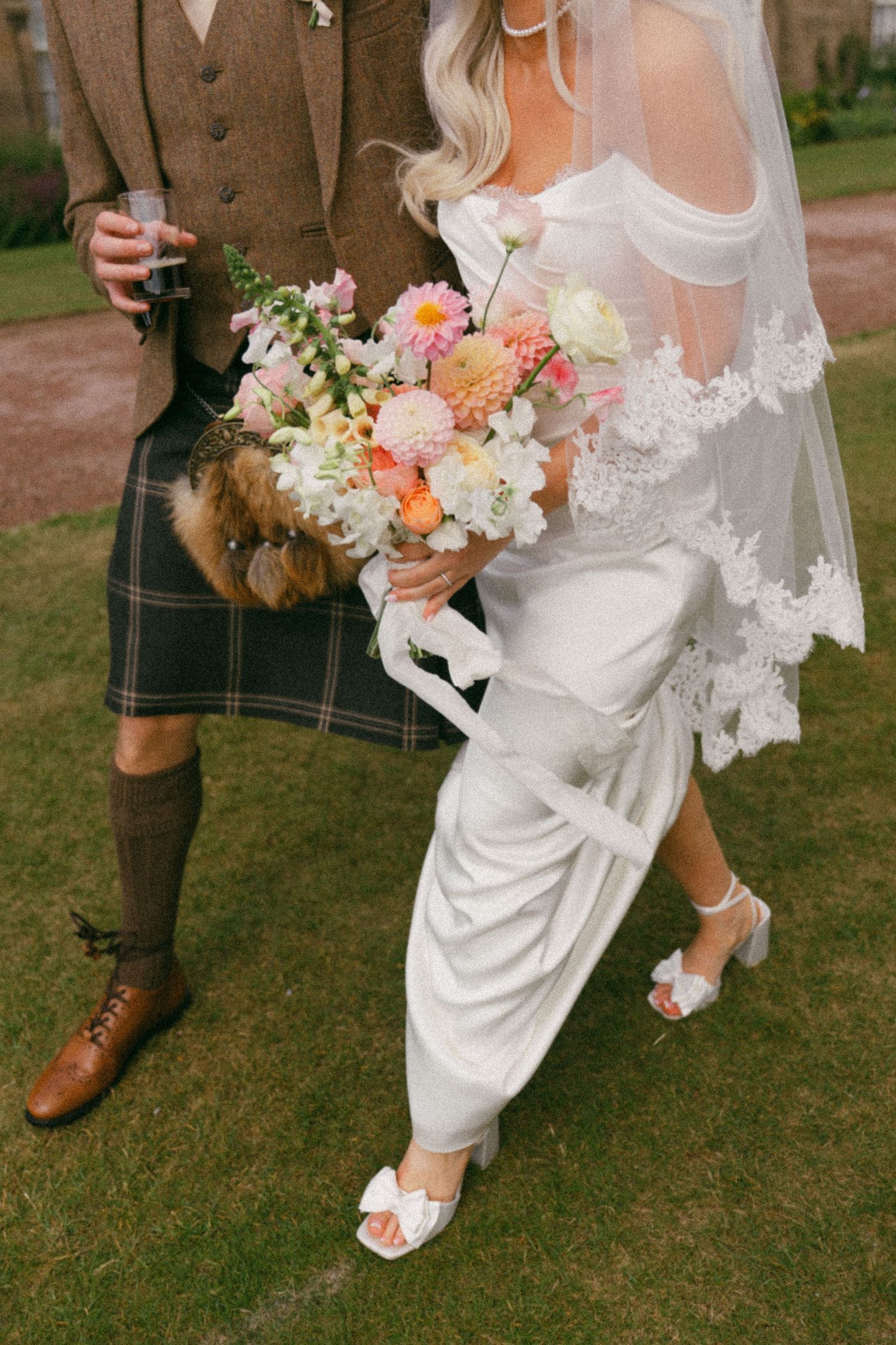 Four closeup shots of bridal details showing a wedding dress, kilt, bouquet and shoes on grass in a garden setting.