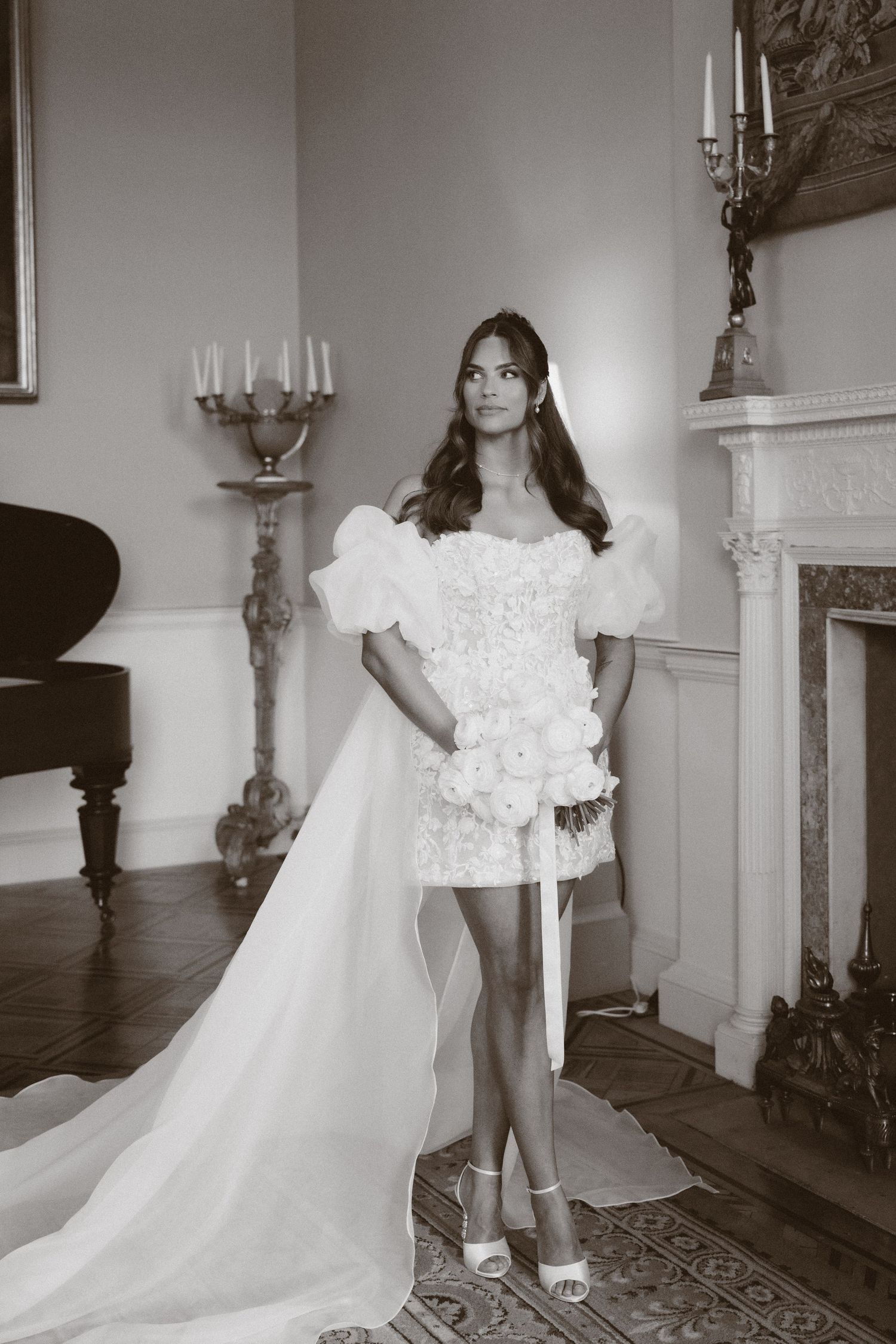 A series of black and white photographs showing details of a vintage wedding dress with ruffles and a flowing train.