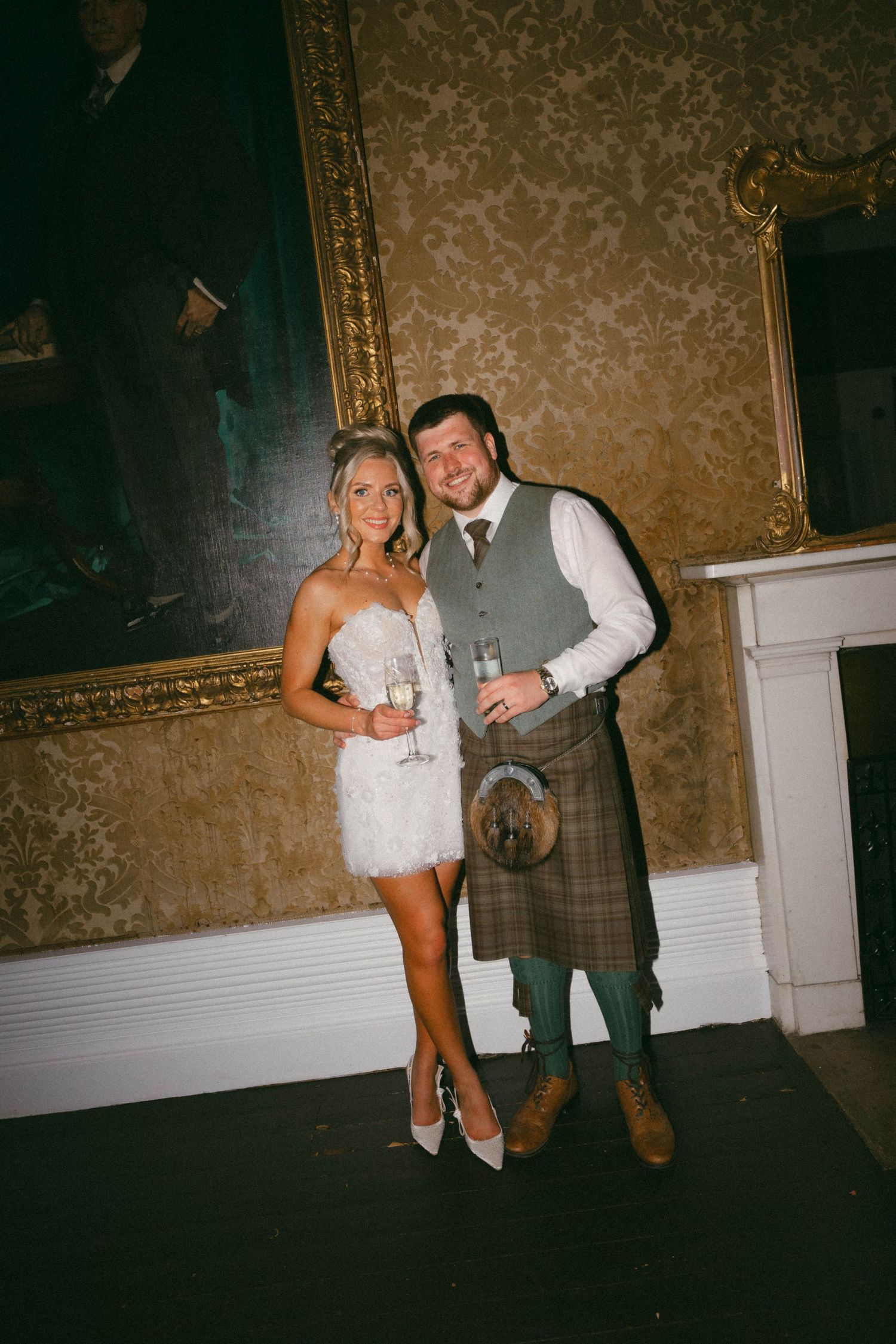 A wedding couple poses together in a dimly lit room with ornate wallpaper and vintage decor in a four-image collage.