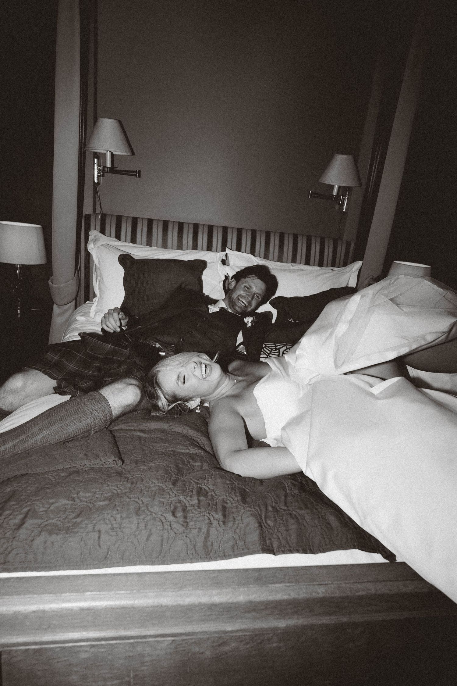 A series of five black and white photographs showing someone sleeping in different positions on a bed with white sheets.