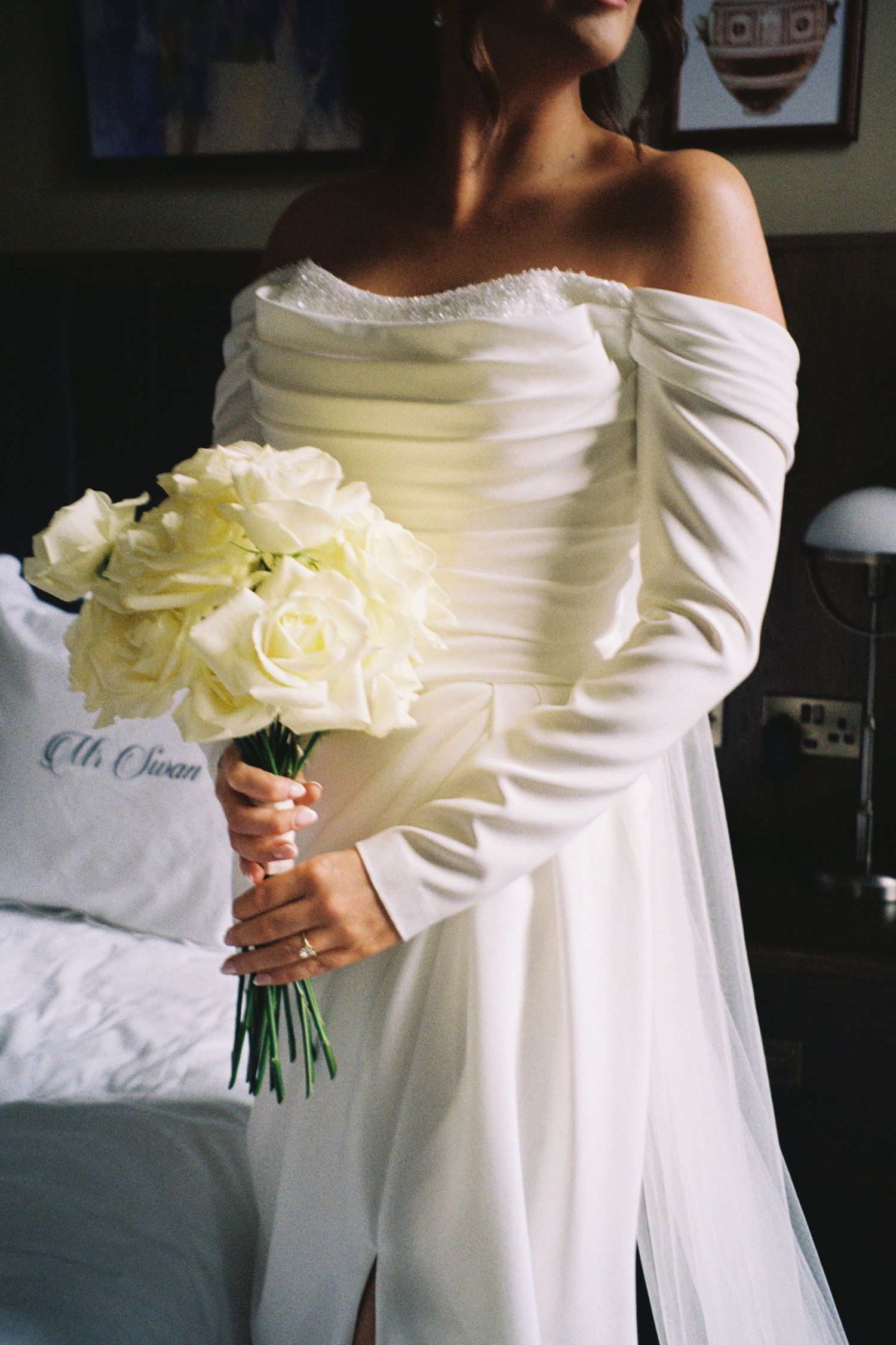 A series of elegant white bridal photos showing an off-shoulder wedding dress and cream rose bouquet in natural light.