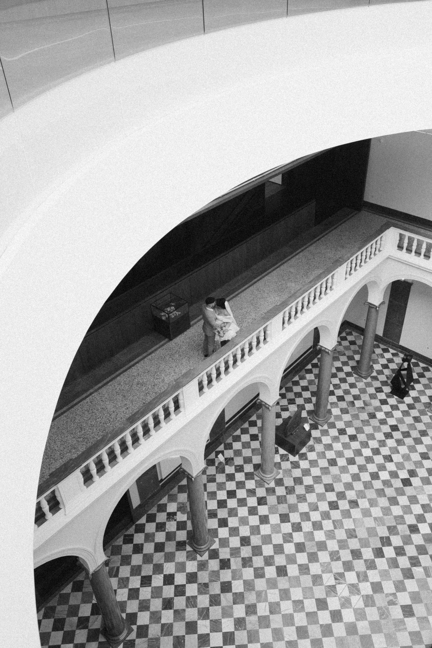 High angle view of a checkered floor courtyard with white arches and columns. Aberdeen art gallery wedding, Scottish wedding photographer