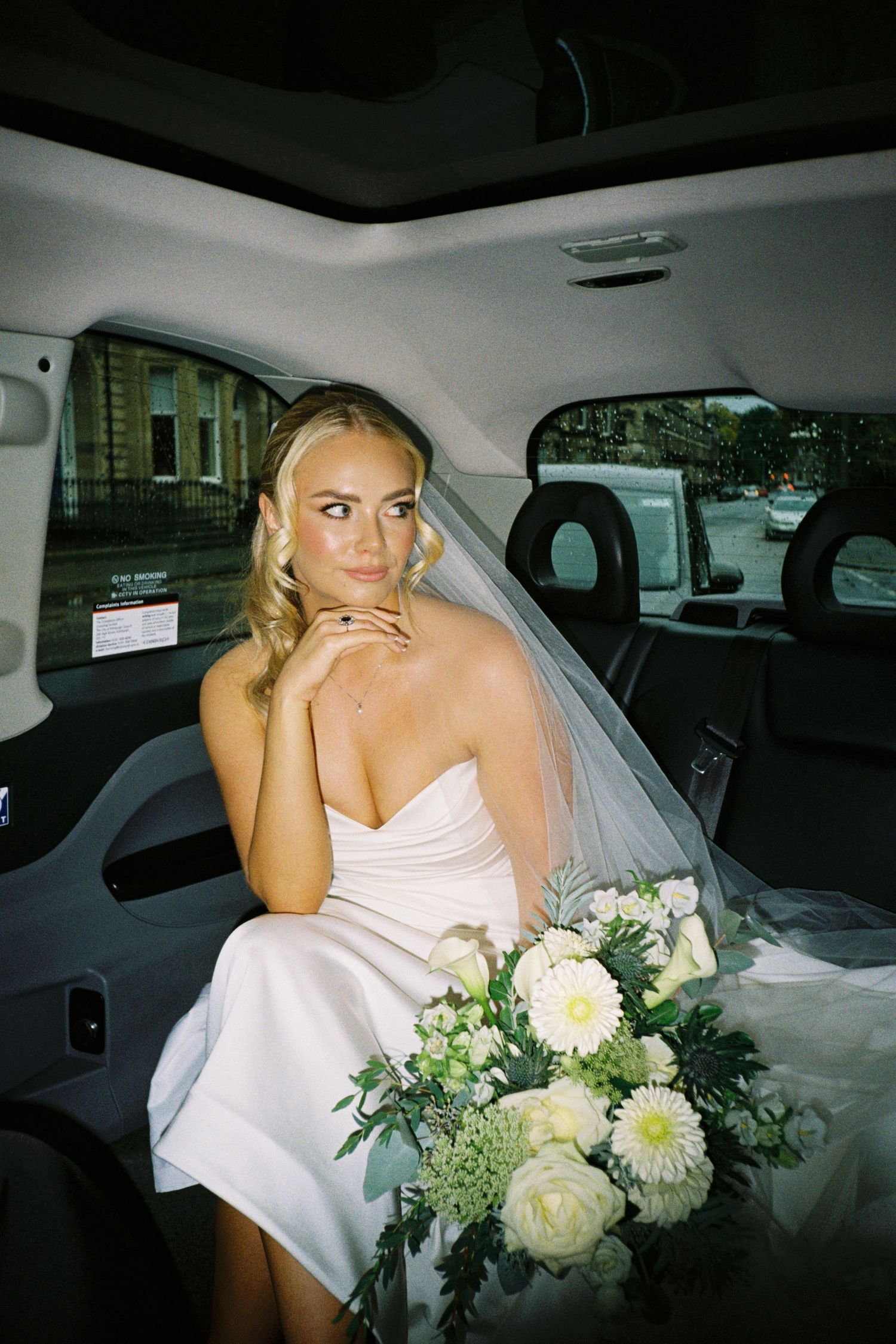 A sequence of five photos showing a person in a white dress sitting in a car with a bouquet of white and green flowers.