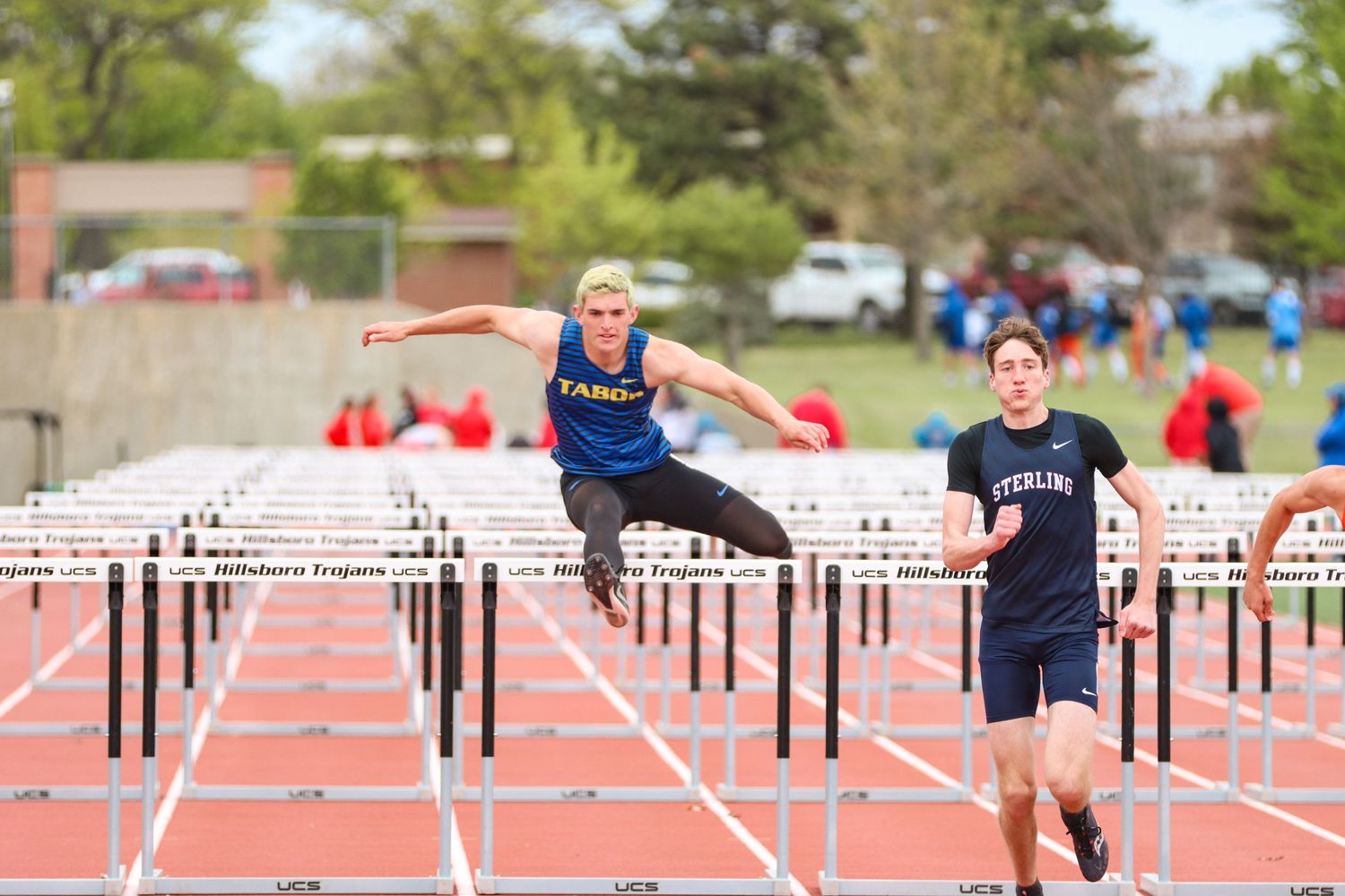 Athlete competes in hurdles race during track and field event.
