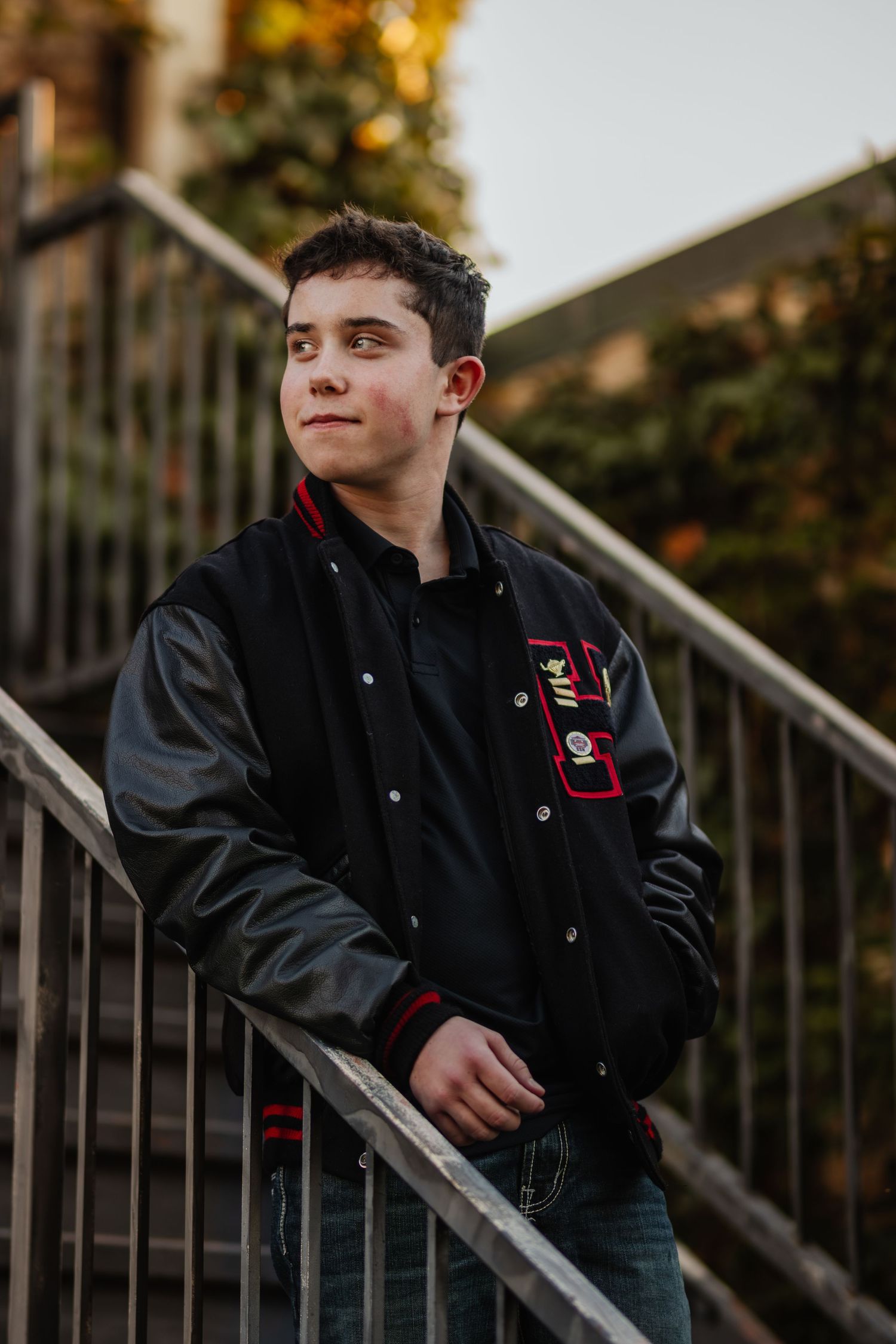 A person in a black jacket poses on metal stairs during golden hour, creating a dynamic series of portrait shots.