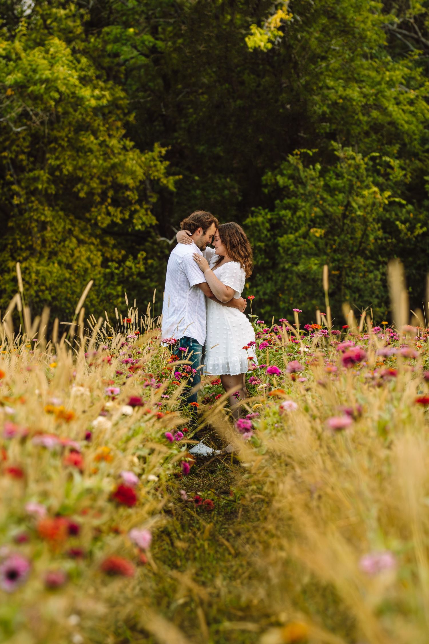 Romantic moment in a vibrant wildflower meadow with pink and purple blooms swaying in the golden summer light.