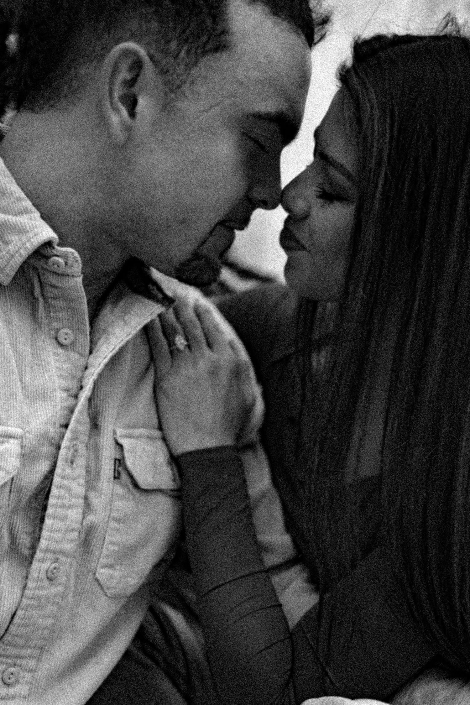 A series of black and white romantic photographs showing intimate moments between a couple in close embrace.