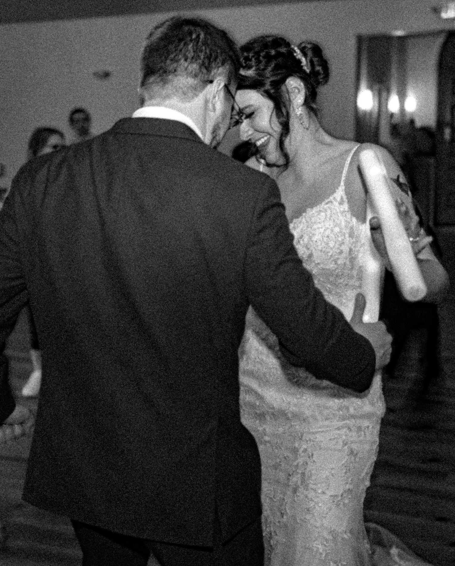 Black and white wedding dance sequence showing intimate first dance between newlyweds in formal attire.