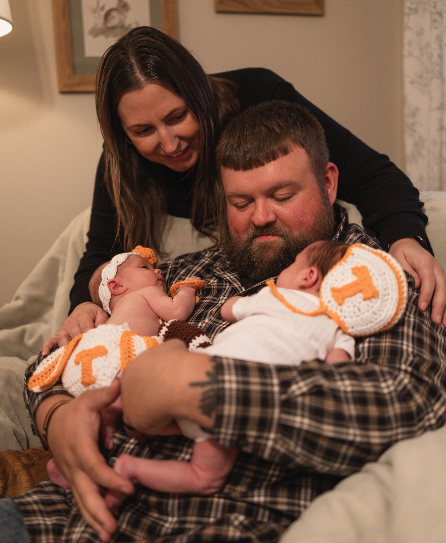 Multiple photos of a newborn wearing orange and white being held lovingly.