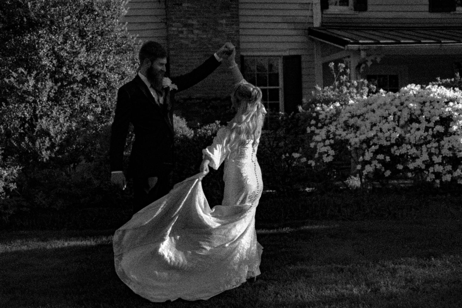 Black and white wedding photos captured in outdoor garden setting.