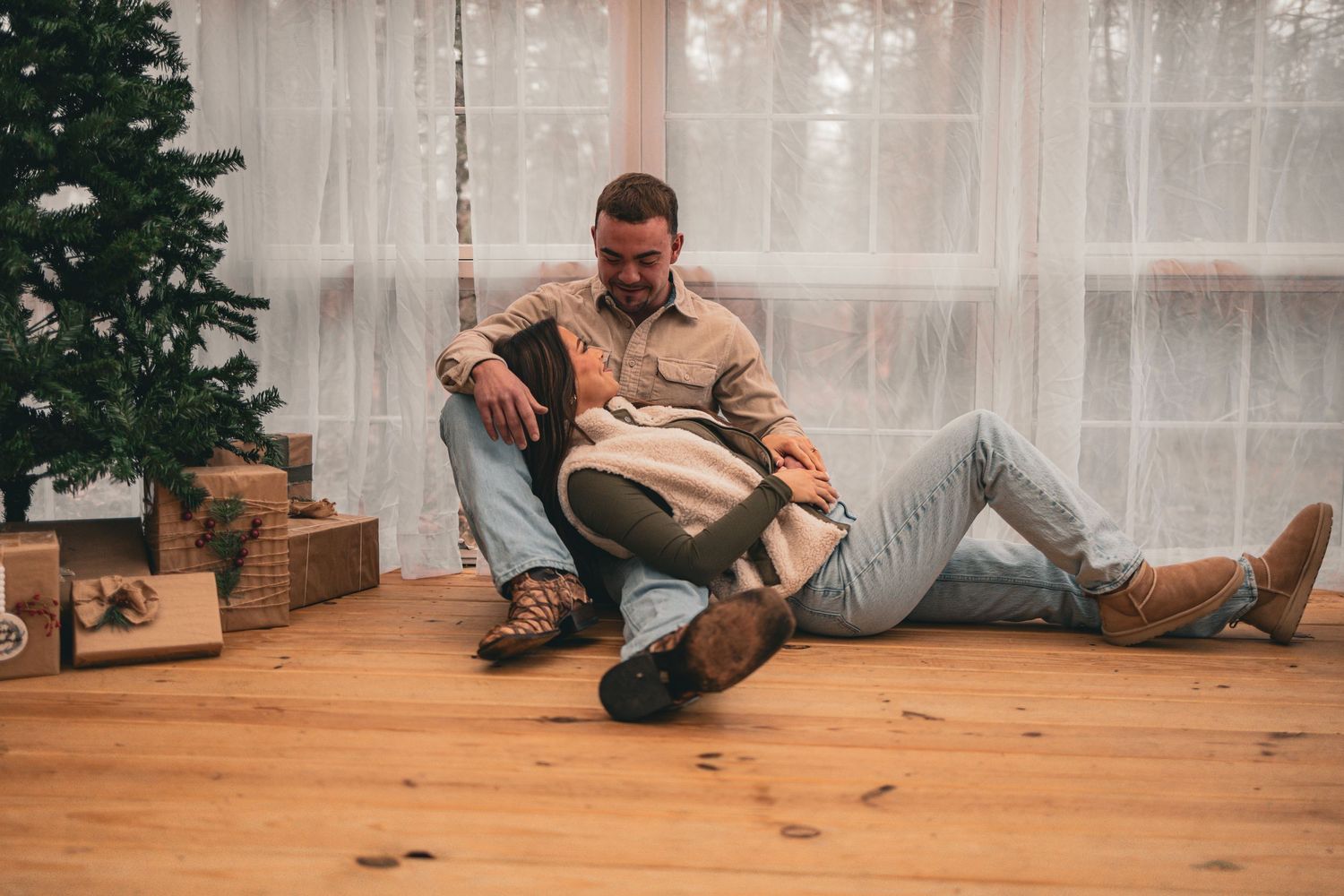 A sequence of photos showing someone falling backwards on a wooden floor near a Christmas tree.