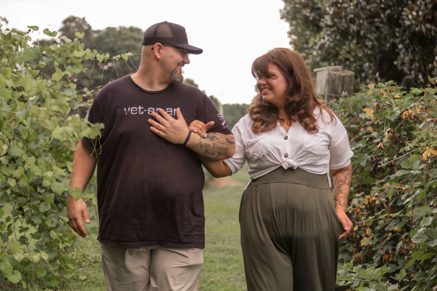 A sweet moment shared between two people in a vineyard setting.