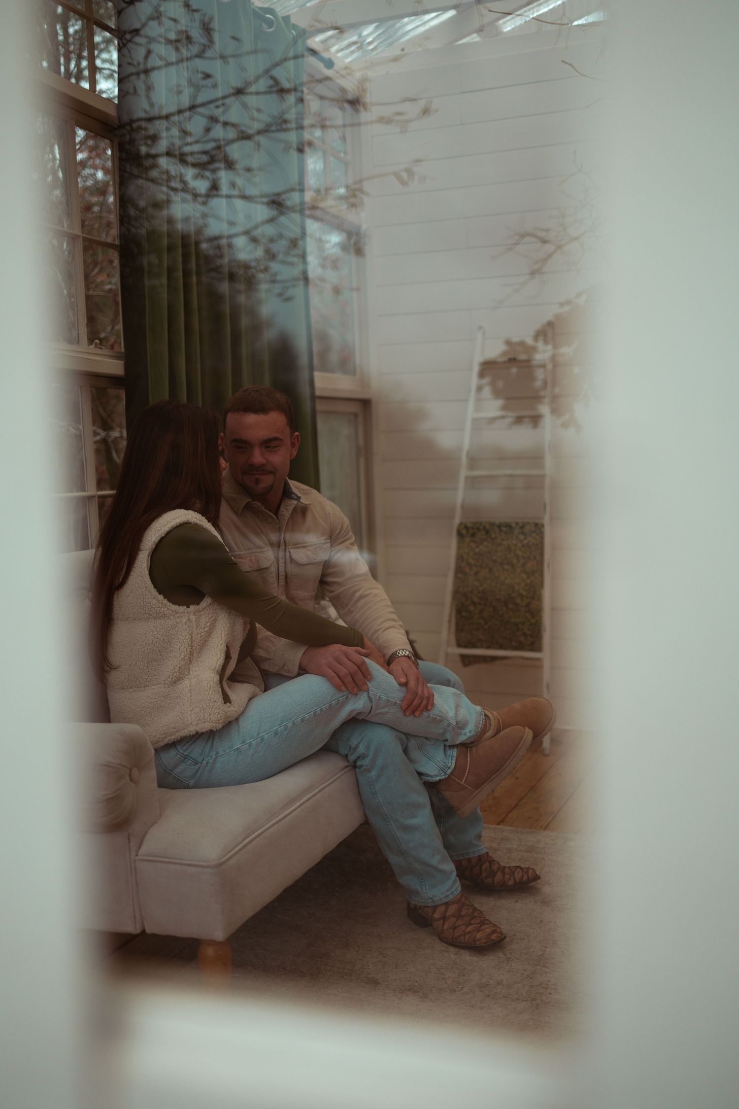 Multiple dreamy, overlapping images show a person sitting on a couch in casual clothing with a soft, ethereal quality.
