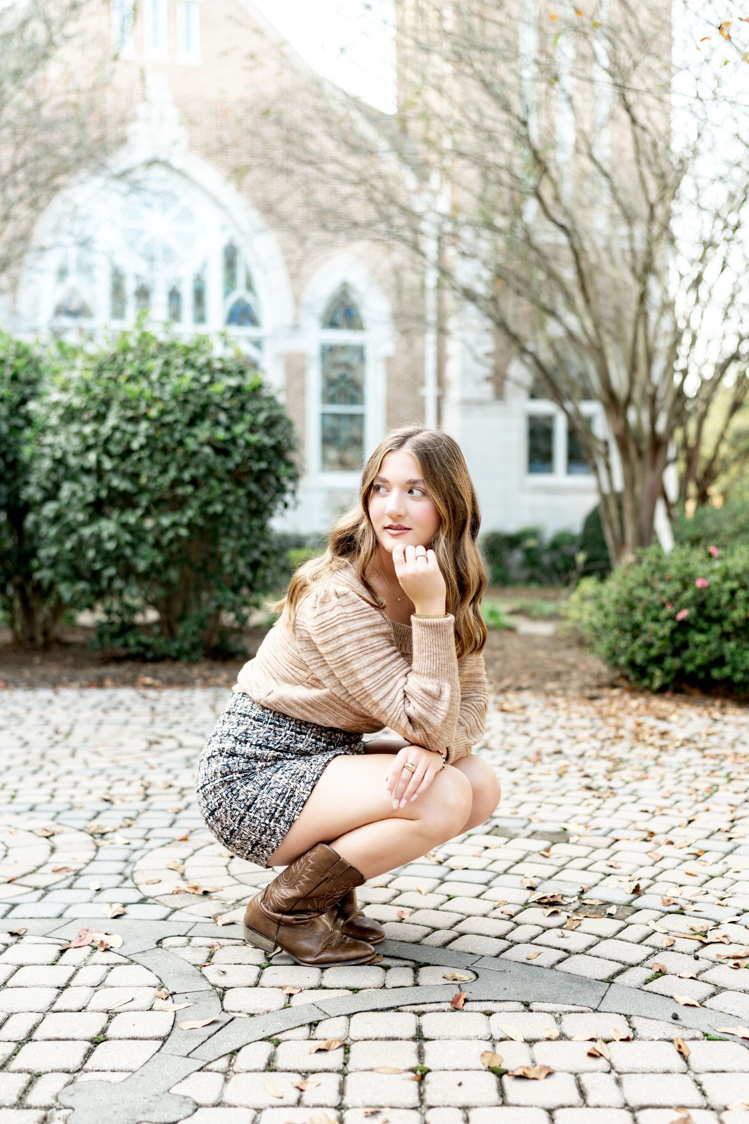 A series of artistic photos taken on a cobblestone path with a church and trees in the background.