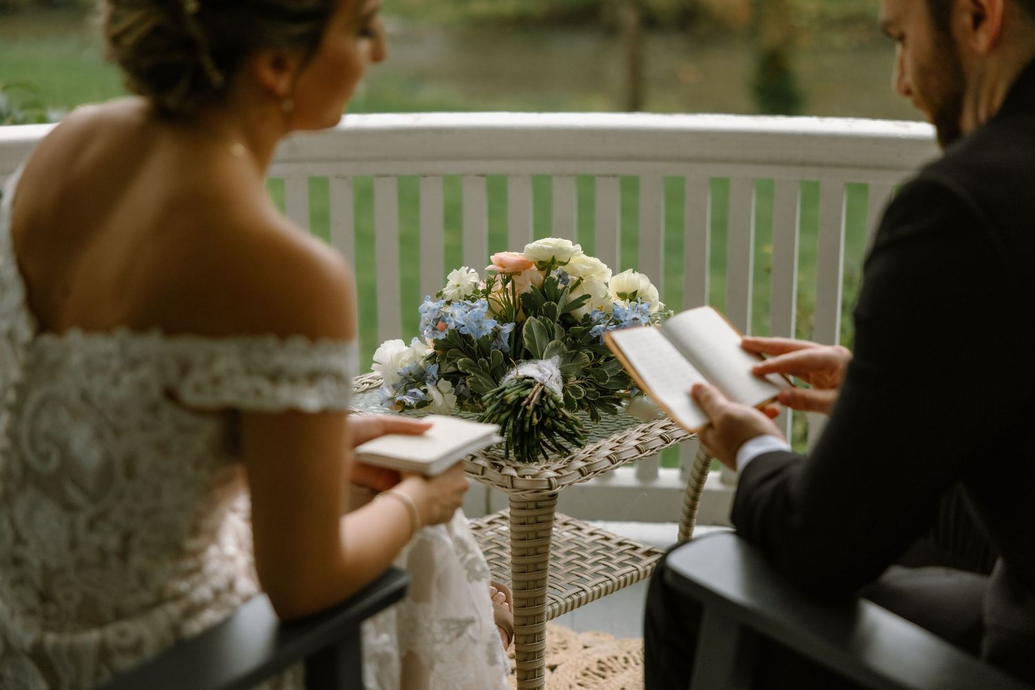 Bride and groom exchanging vows with a floral bouquet centerpiece during an intimate outdoor wedding ceremony.
