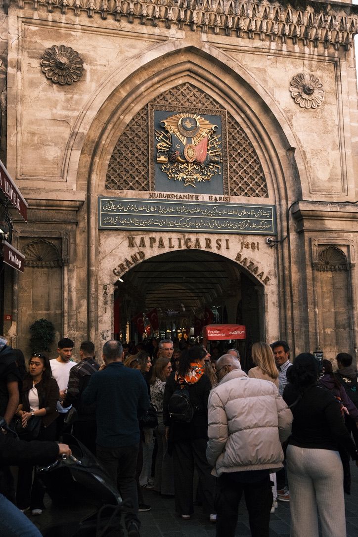 Crowd gathering at the historic Grand Bazaar entrance gate in Istanbul, Turkey, established 1461.