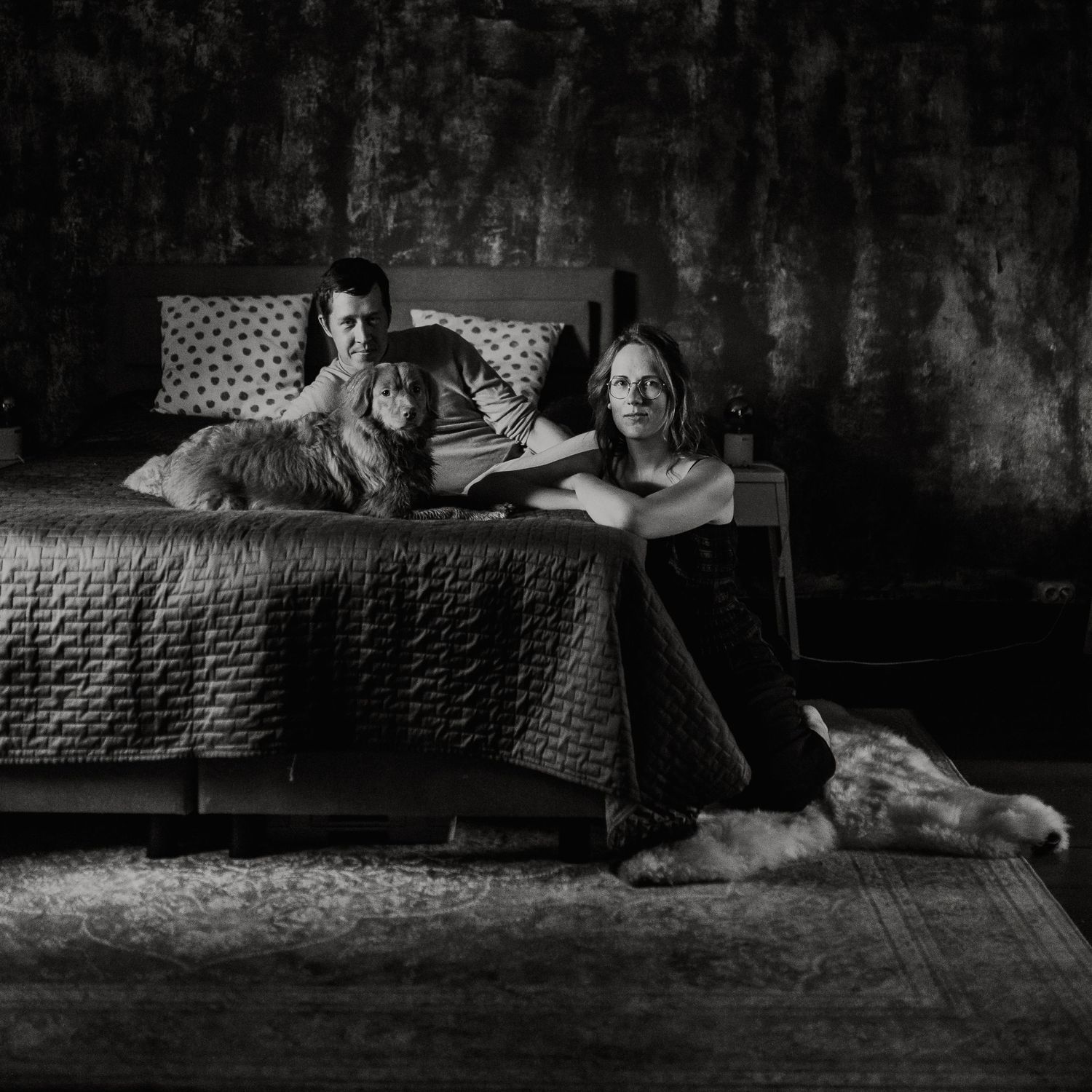 Couple photo with a dog in a bedroom