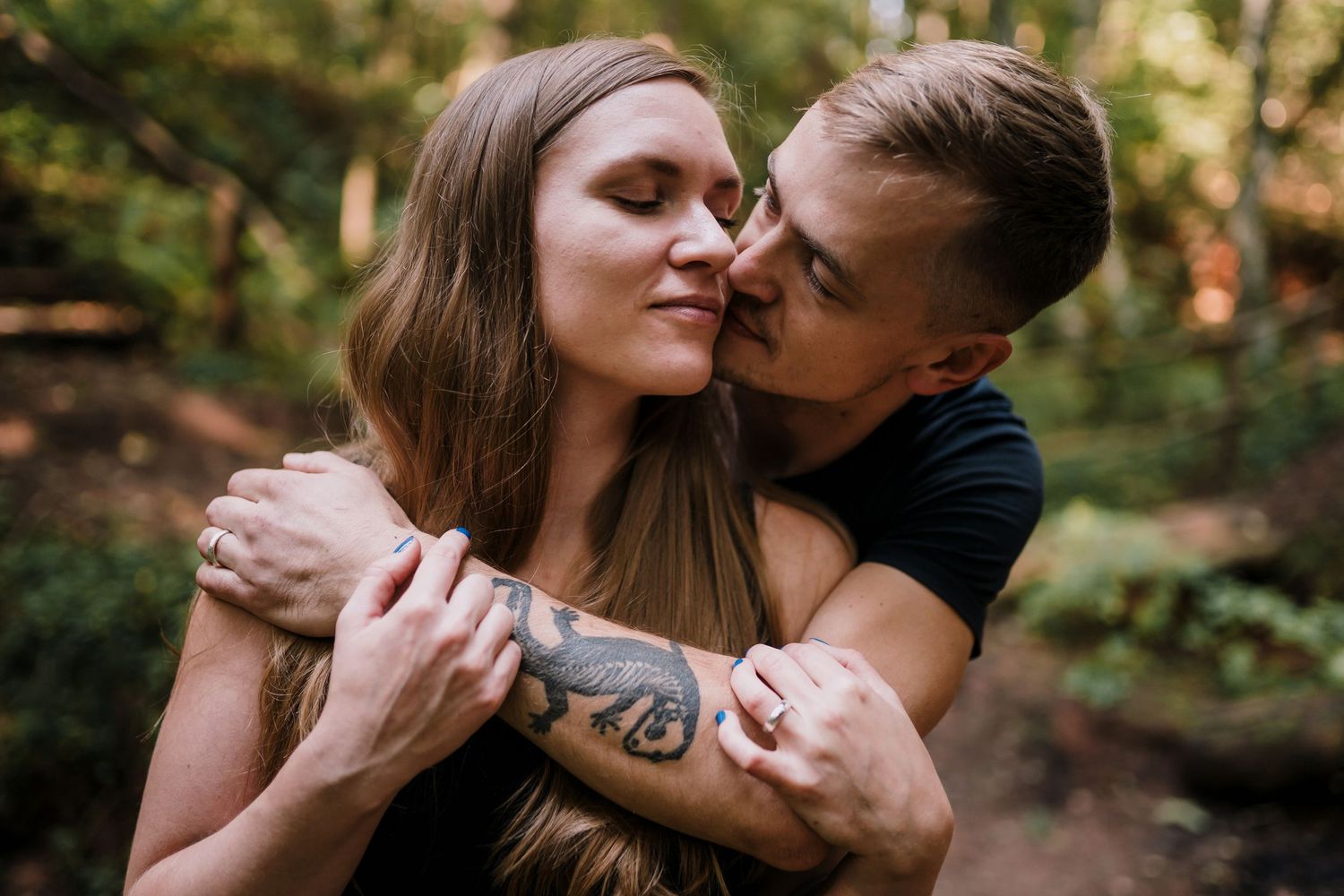A romantic photo of a couple holding each other, man about to kiss the woman