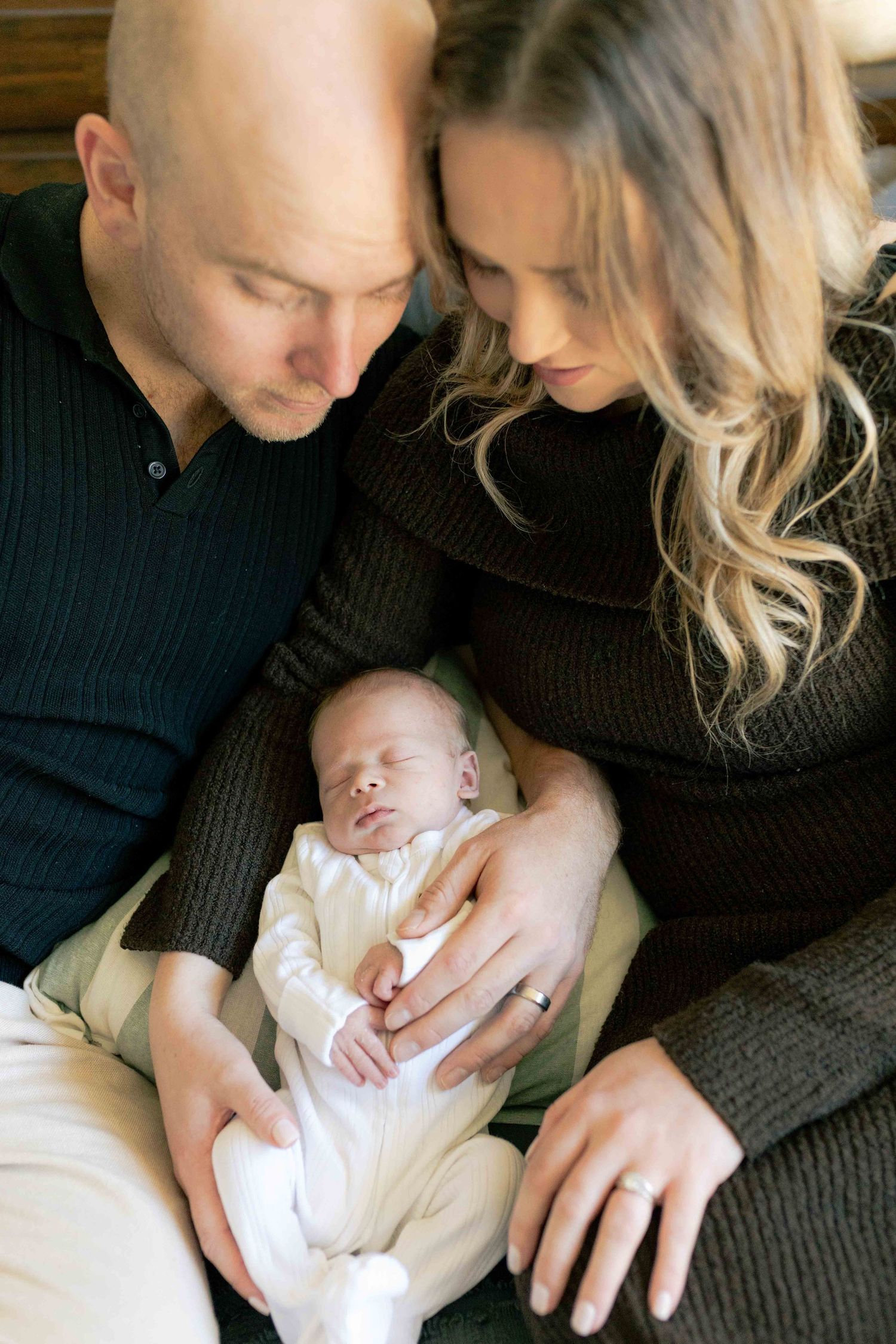 Looking down from on top of the parents head looking down at the newborn boy lying in their laps Newborn photography Melbourne's West Melton