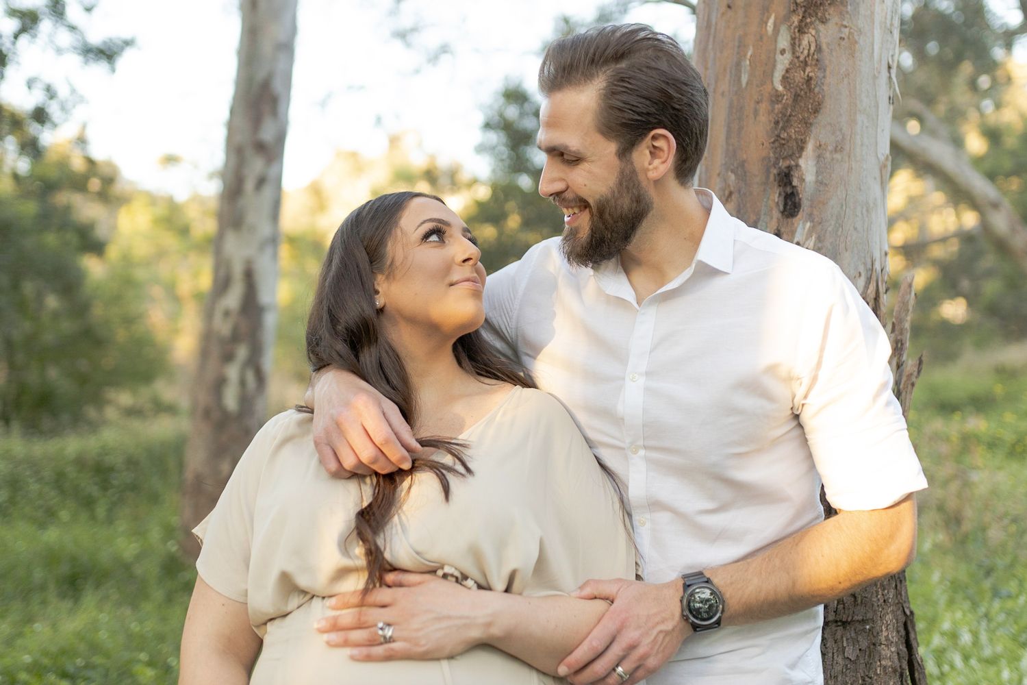 husband and wife hugging and holding mum's belly outdoor maternity session Sunshine North, Melb, Vic